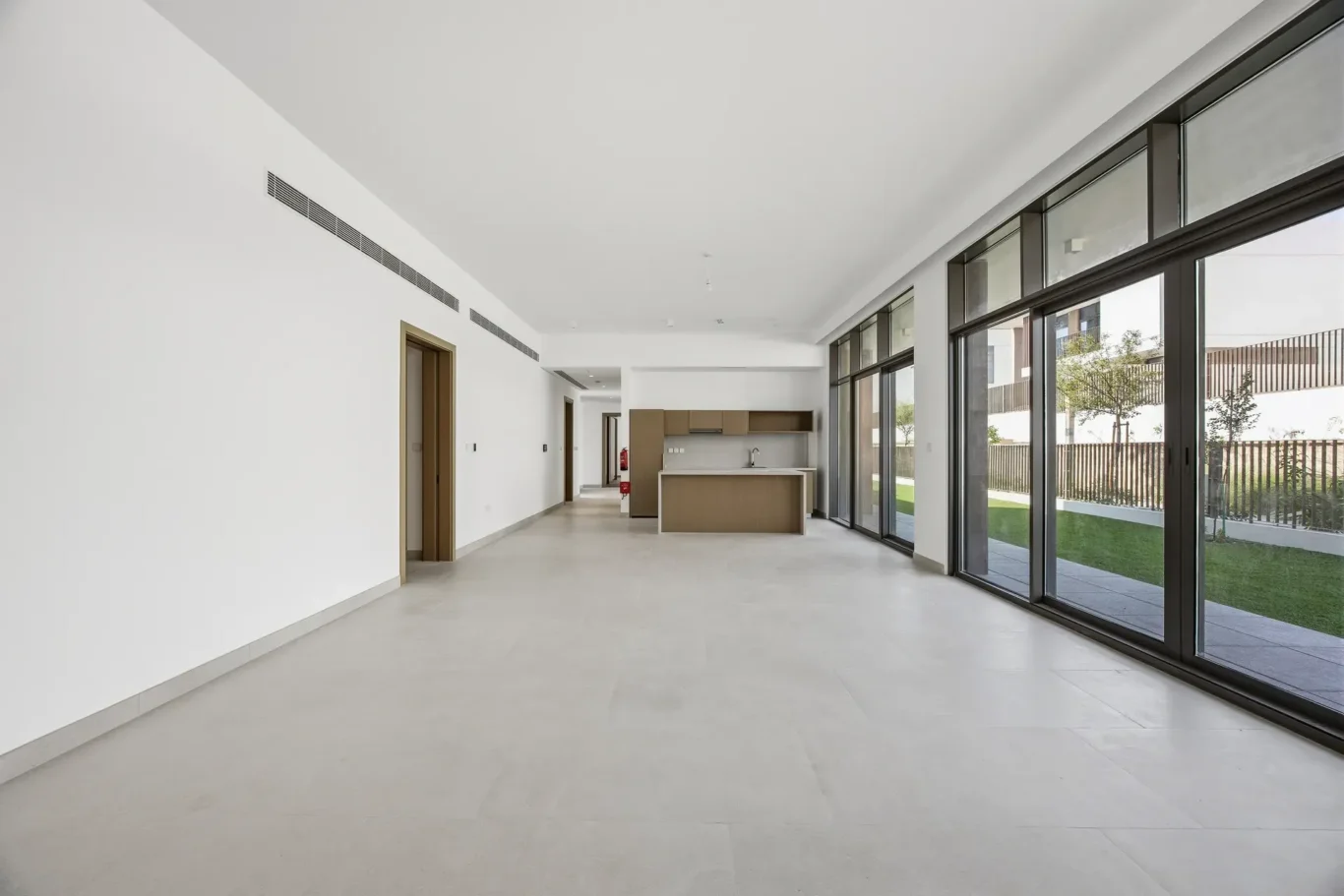 Wide view of the unfurnished living room with garden views. Villa photography by MRPS in Dubai for ELITE Property Brokerage.