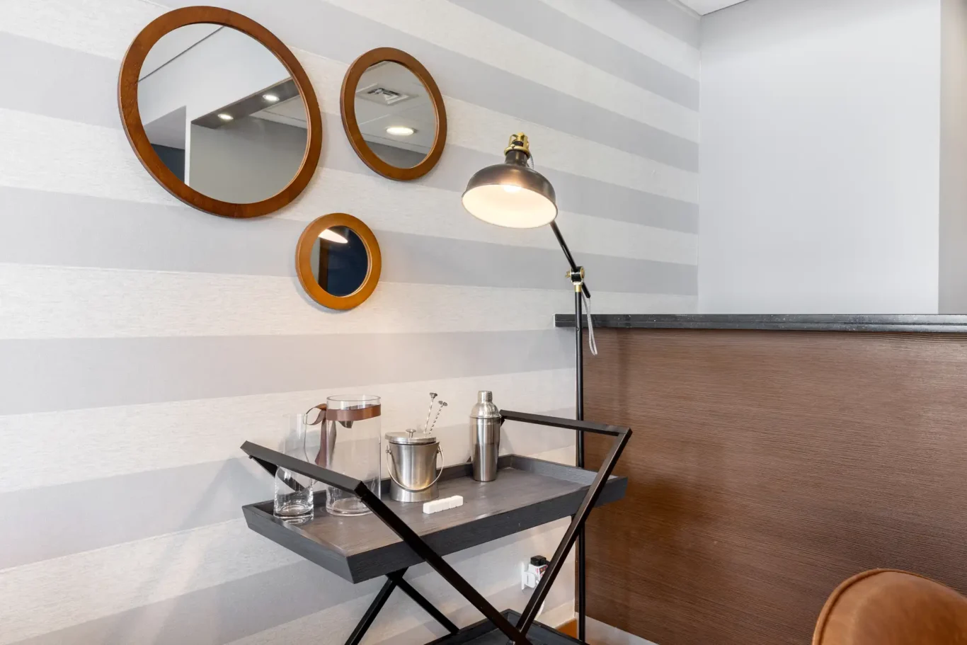 Round mirrors and side table in the living room in a Your Stay Apartments one-bedroom at Burj Daman, DIFC, Dubai.