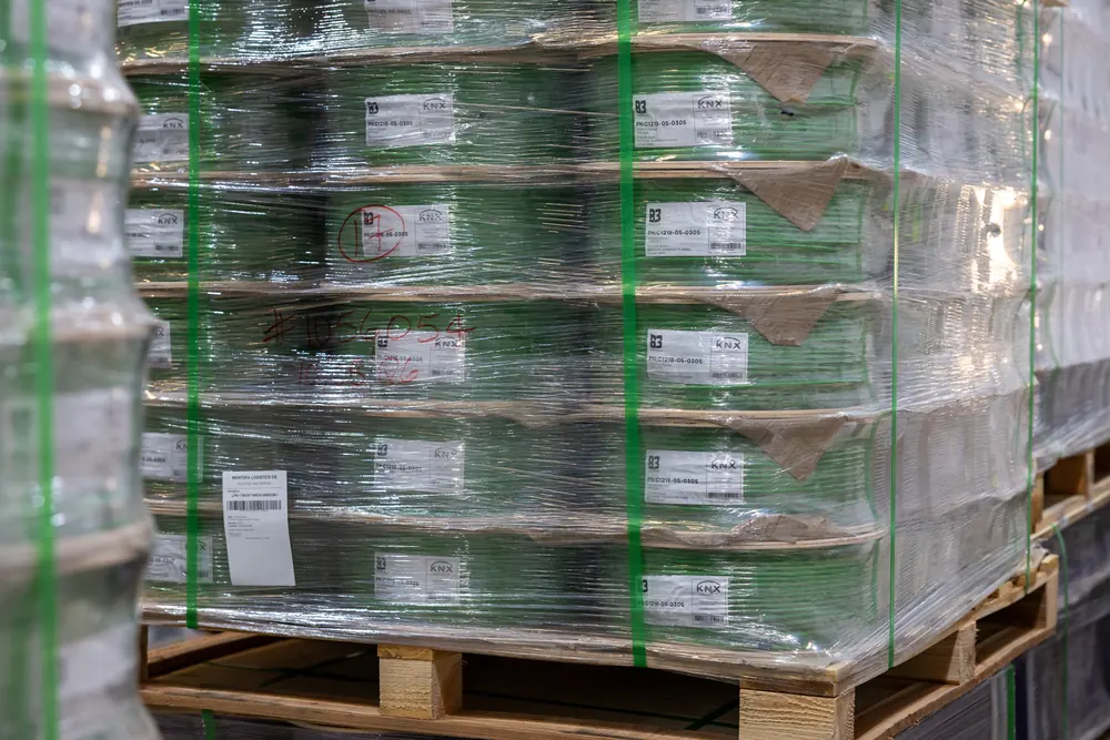Pallet of green B3 International cable reels wrapped and strapped, photographed in the Jebel Ali warehouse.