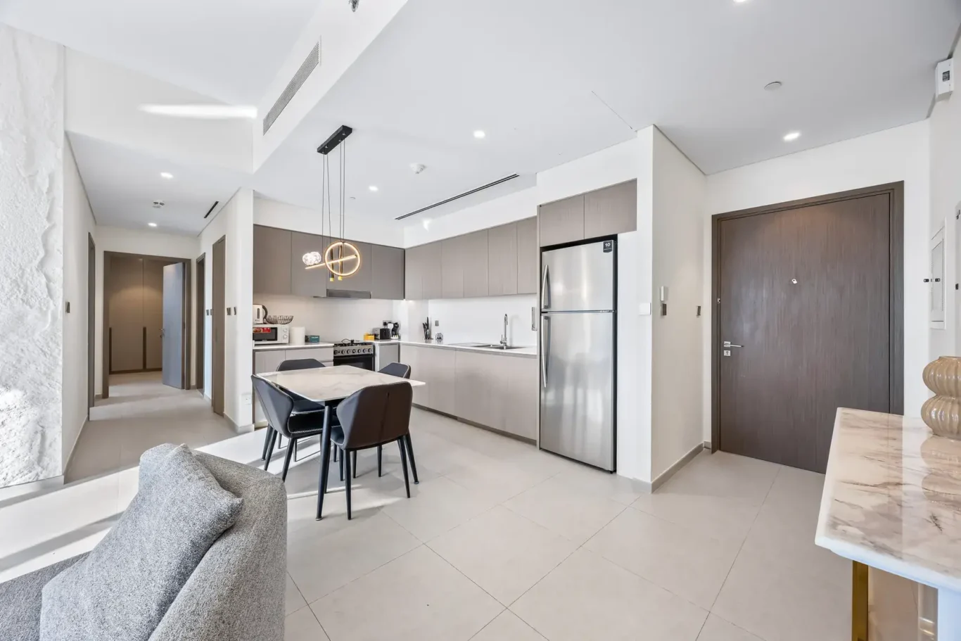 Kitchen and dining area seen from the living room. Airbnb photography by MRPS for Solea Stay in Dubai.