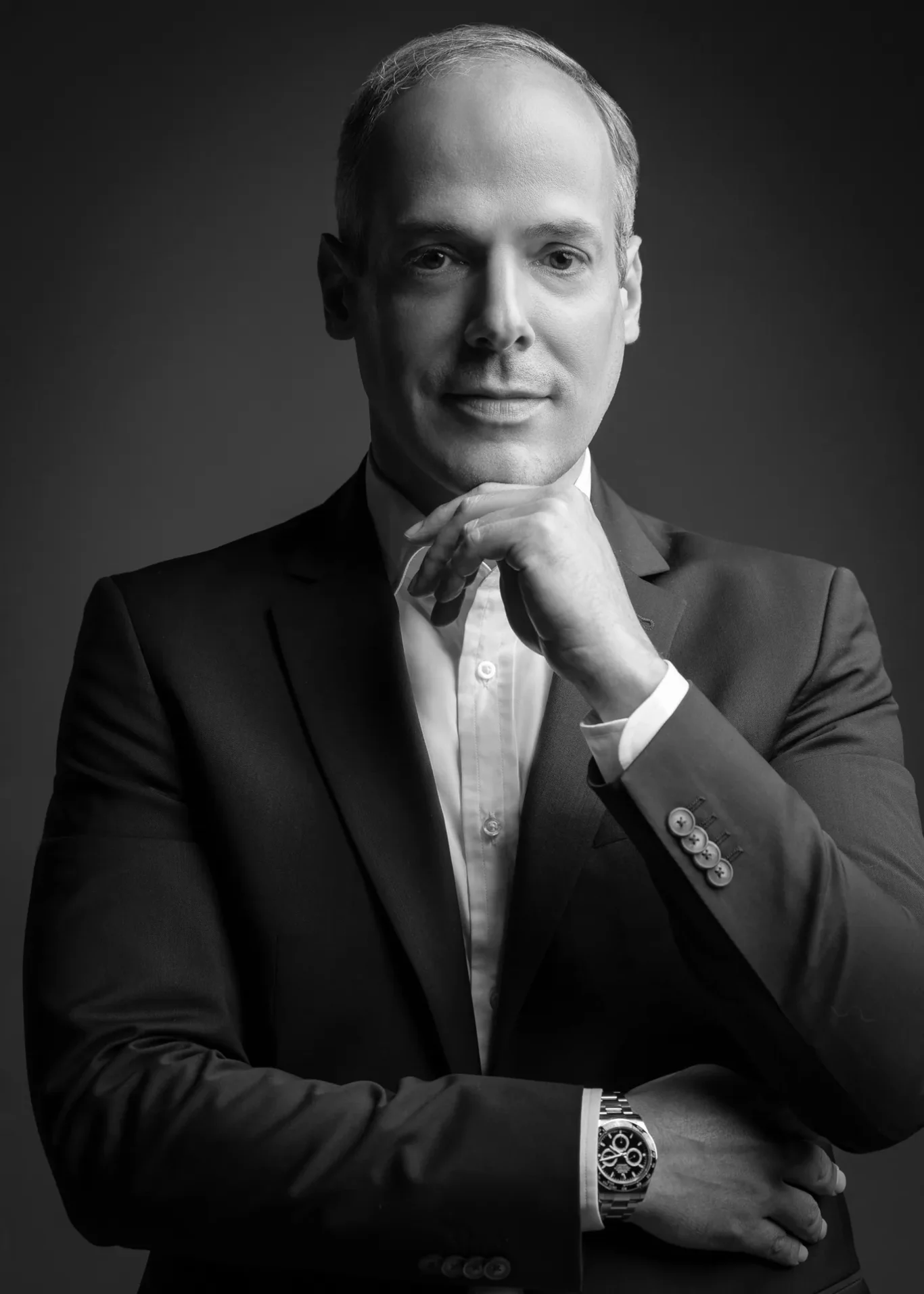 Black and white thinking pose with hand on chin. Corporate business portrait of a Dubai CEO, photographed at the MRPS studio in Business Bay.