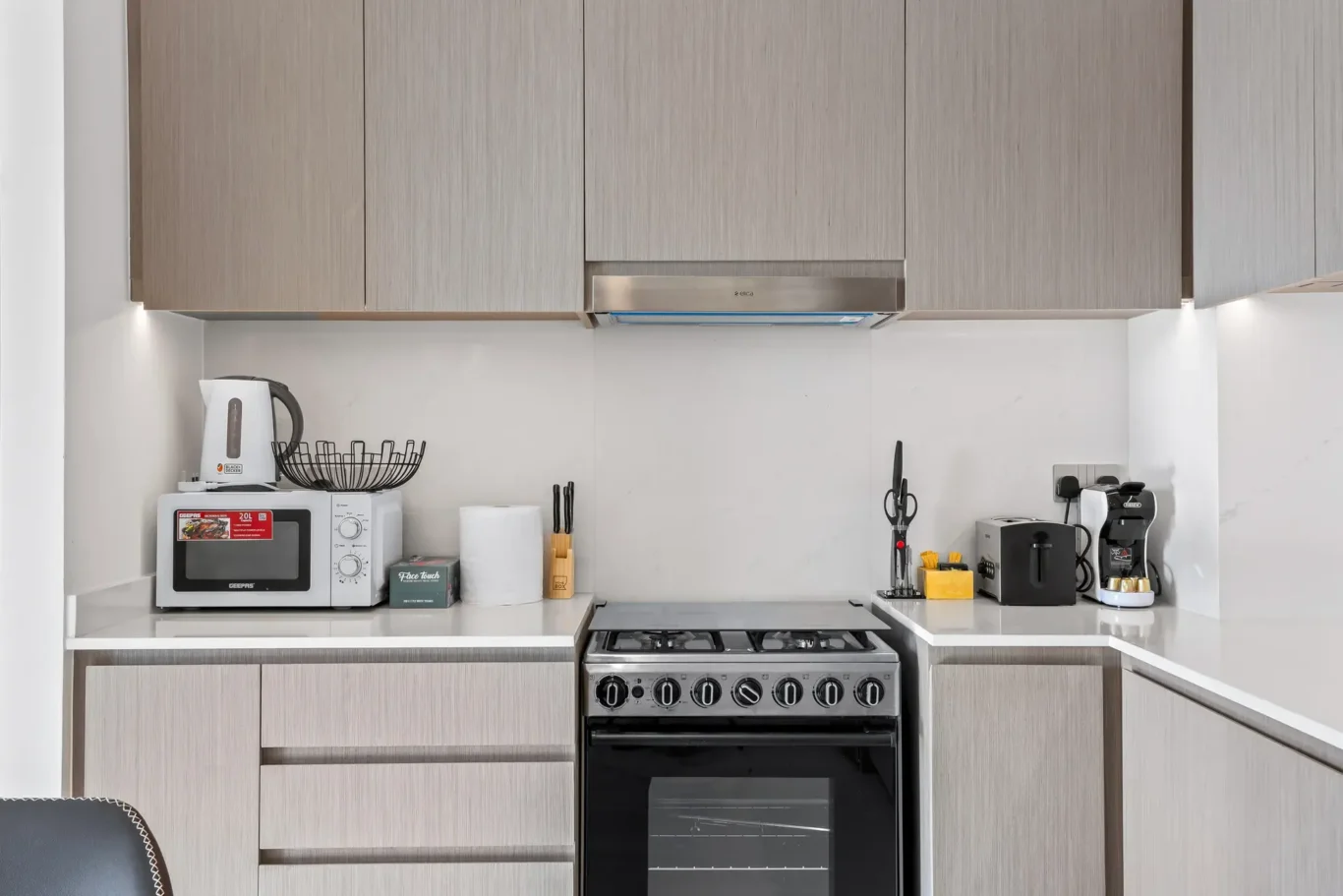 Fully equipped kitchen with gas cooker, coffee machine and microwave. Airbnb photography by MRPS for Solea Stay in Dubai.