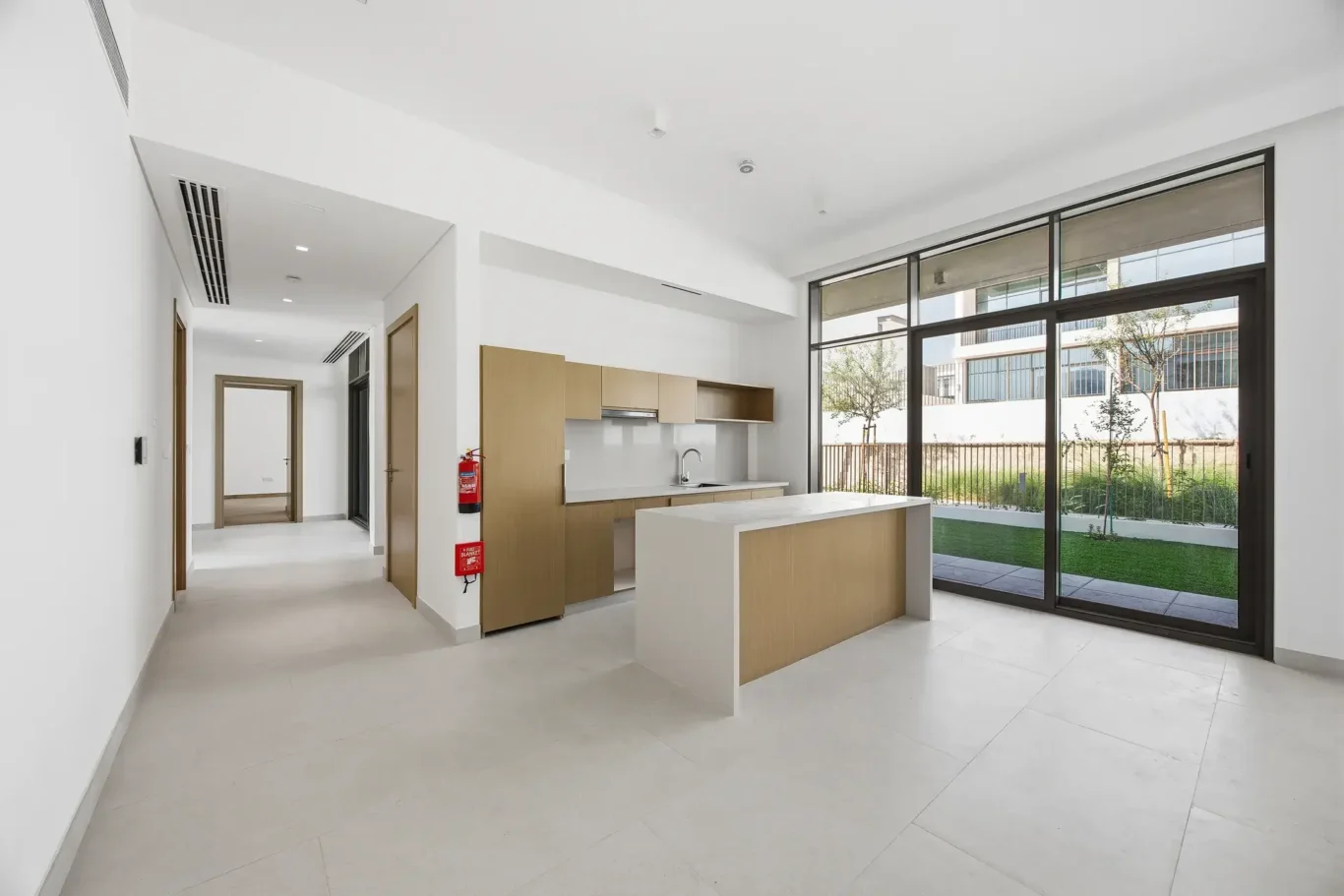 View across the living area toward the open kitchen. Villa photography by MRPS in Dubai for ELITE Property Brokerage.