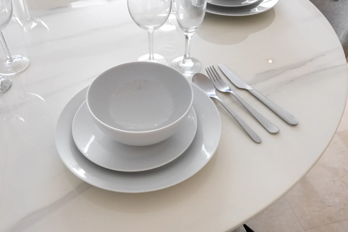 Table setting with plates and glasses in a Your Stay Apartments one-bedroom at Sky Gardens, DIFC, Dubai.