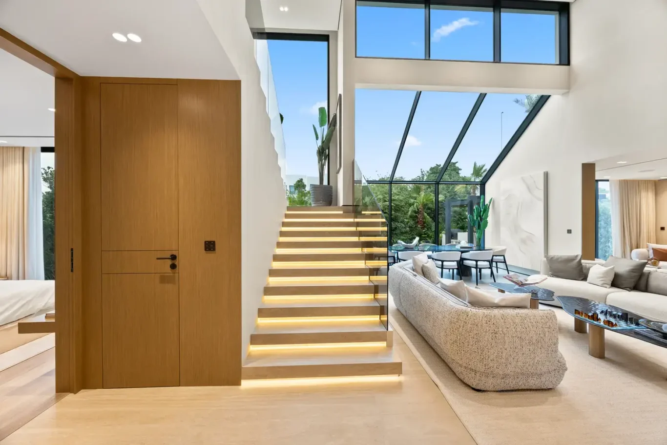 Staircase with lit steps beside the living room and skylight, luxury villa in Jumeirah Islands, Dubai.
