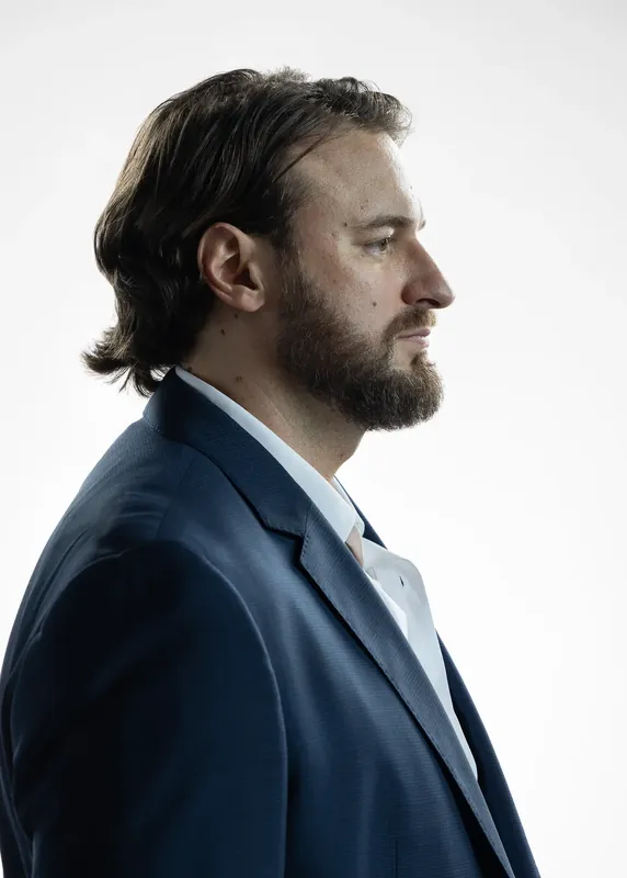 Back three-quarter view showing hair and shoulders. White background reference photo from an AI model training photoshoot at the MRPS studio in Dubai.