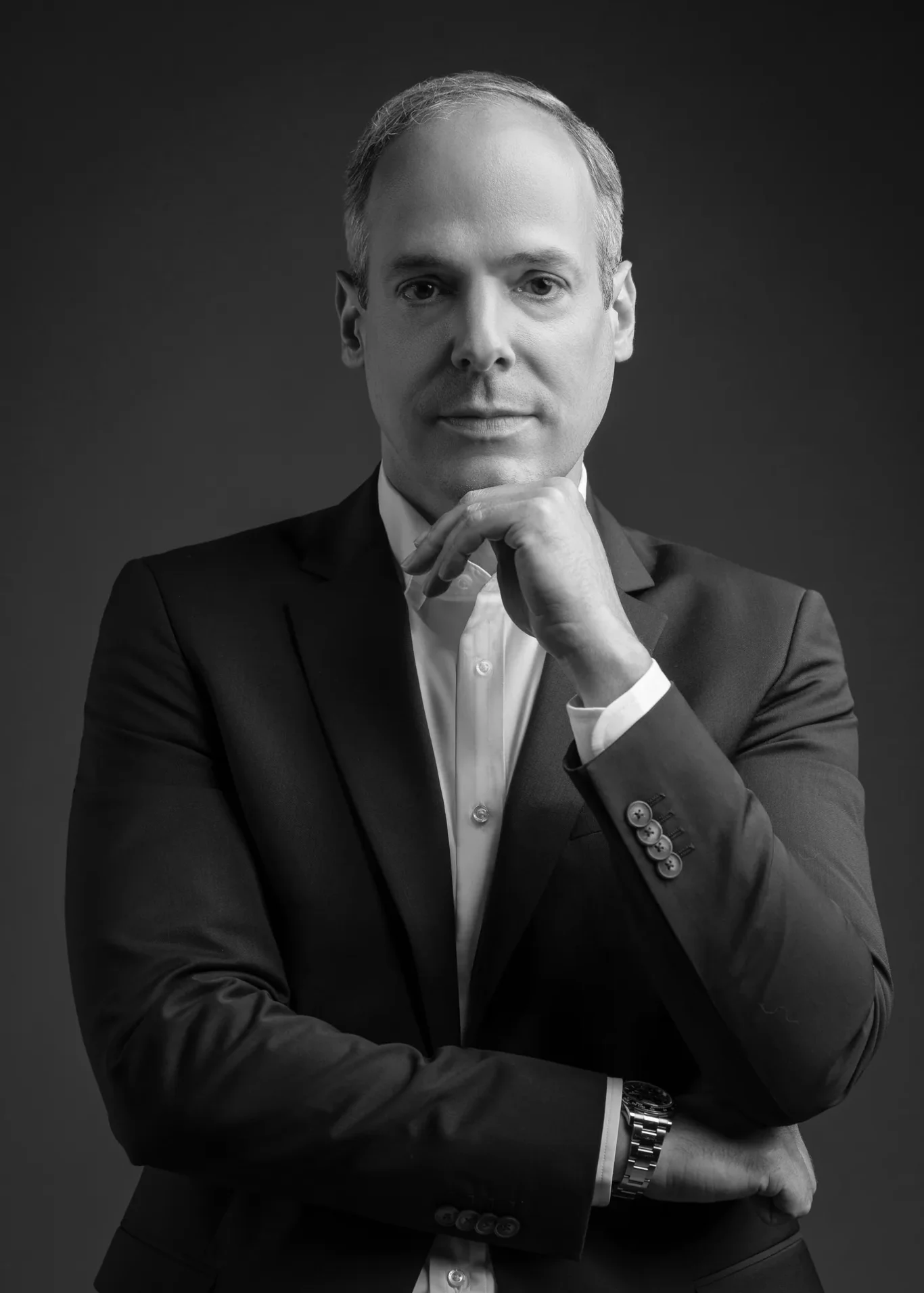 Black and white serious hand-on-chin pose. Corporate business portrait of a Dubai CEO, photographed at the MRPS studio in Business Bay.