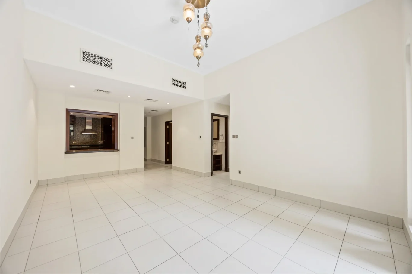 Dining area with arched window detail in an unfurnished two-bedroom garden apartment in Old Town, Downtown Dubai, photographed for ELITE Property Brokerage.
