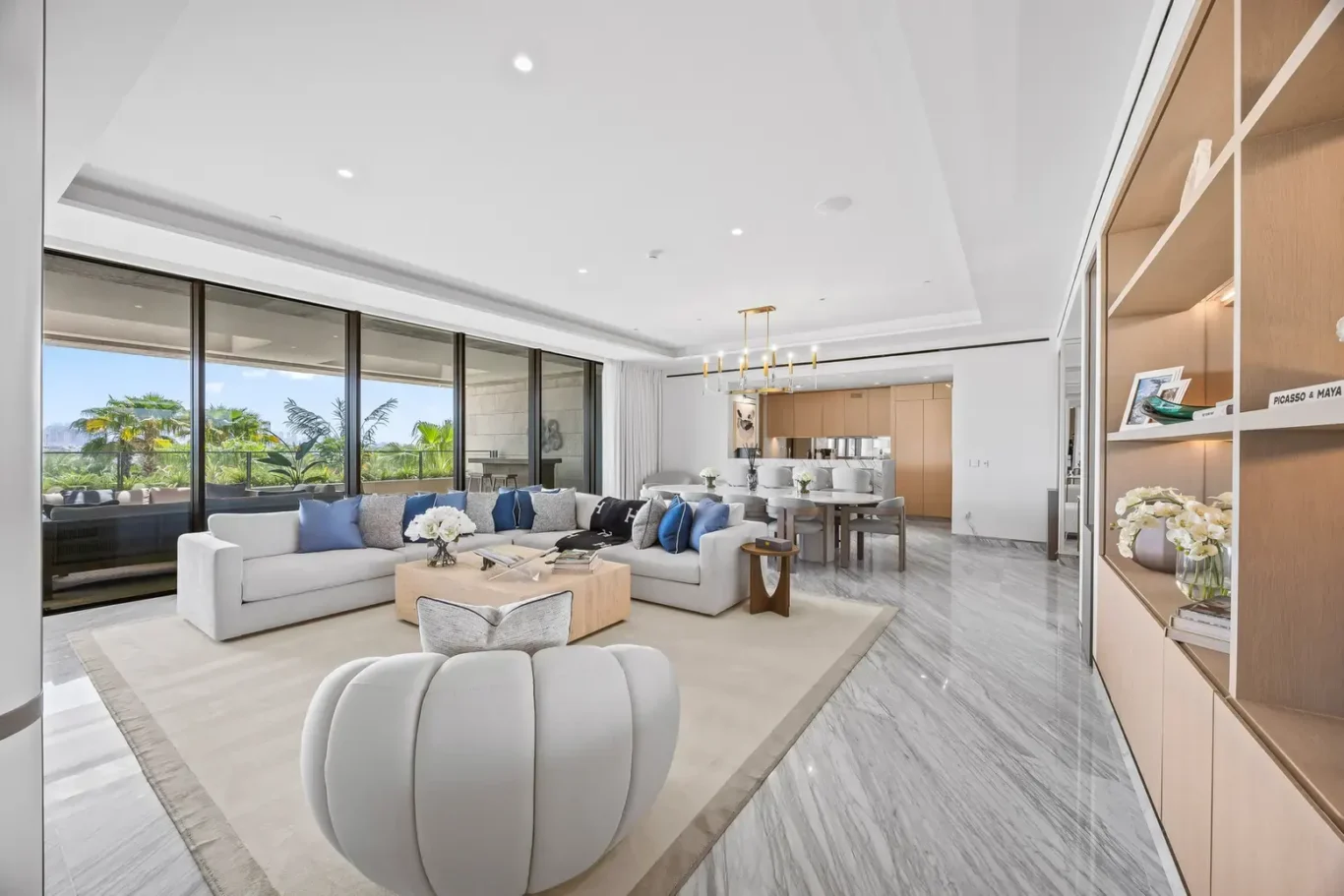 Lounge area beside floor-to-ceiling windows in a furnished three-bedroom residence at Atlantis The Royal, Palm Jumeirah, photographed for Apex Homes Real Estate.