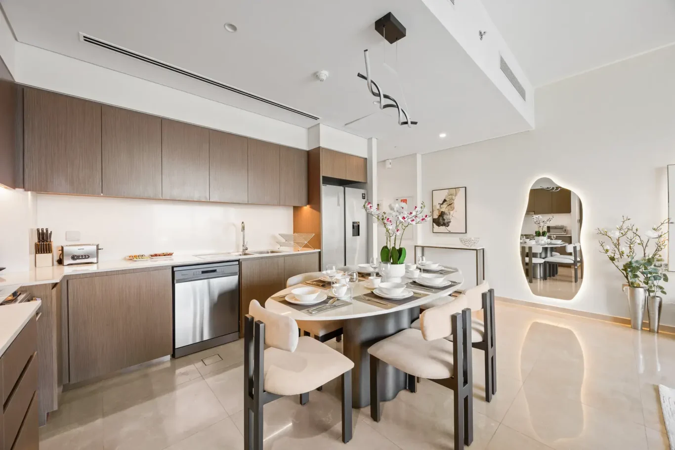 Kitchen and dining table in a two-bedroom StayComfy Holiday Homes apartment at Grande Signature, Downtown Dubai.