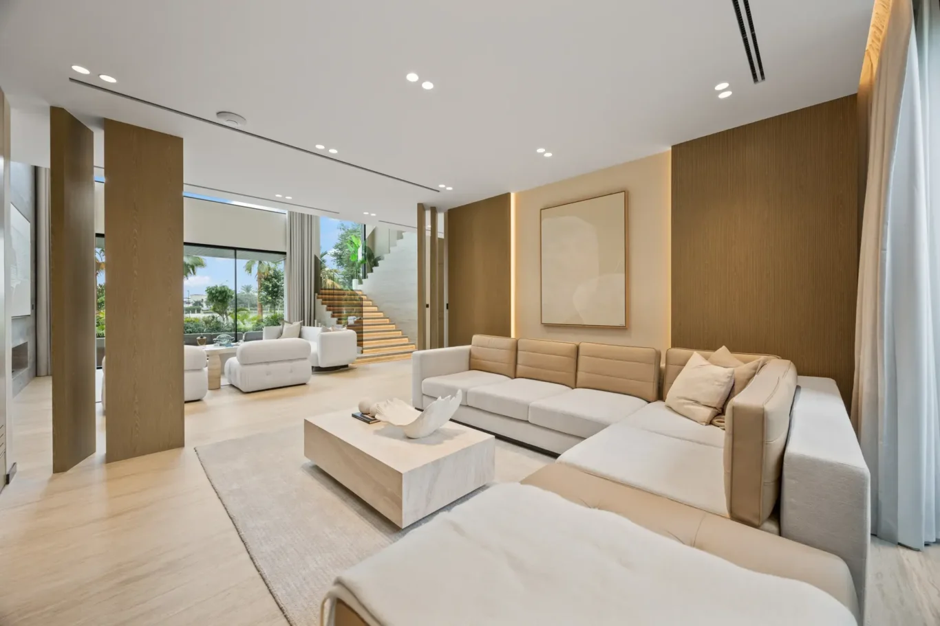 Family lounge sofa looking towards the staircase and living room, luxury villa in Jumeirah Islands, Dubai.