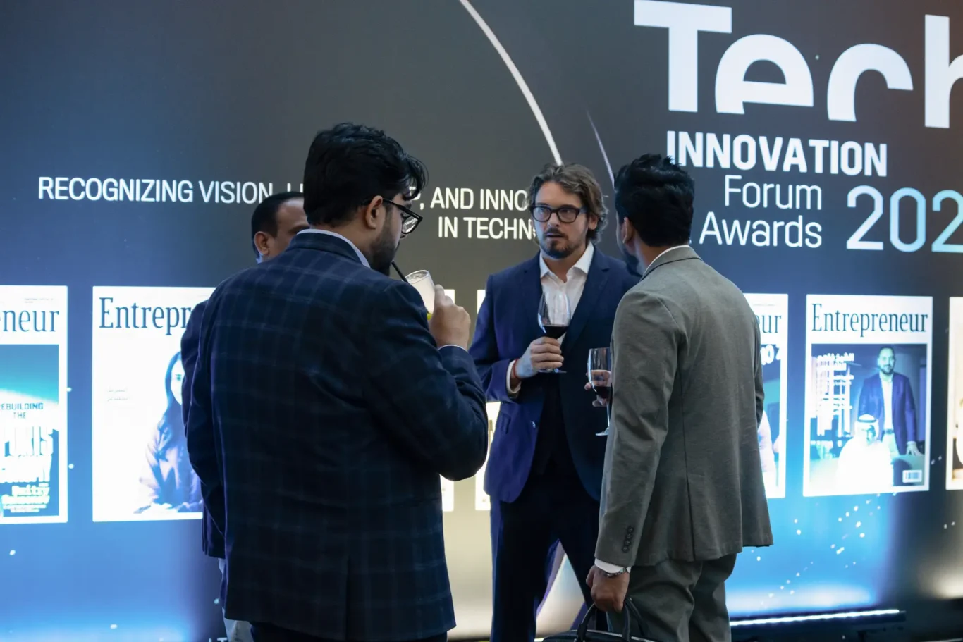 Networking by the Tech Innovation Forum backdrop. Event photography by MRPS for FundedNext at the Tech Innovation Awards 2026, Al Habtoor Palace, Dubai.