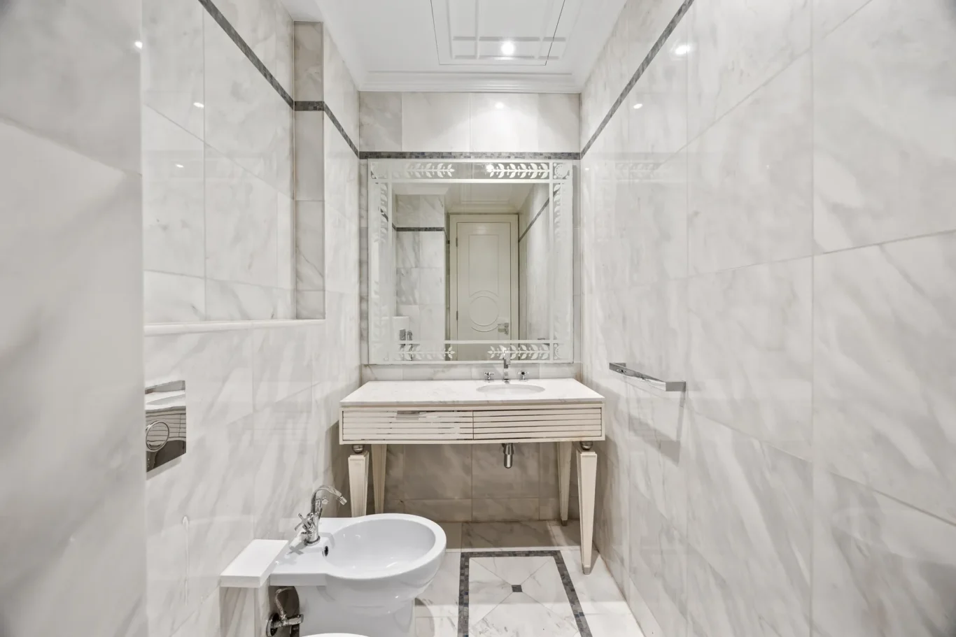Marble powder room with vanity in a three-bedroom residence at Palazzo Versace Dubai, Jaddaf Waterfront, photographed for Concierge Auctions.