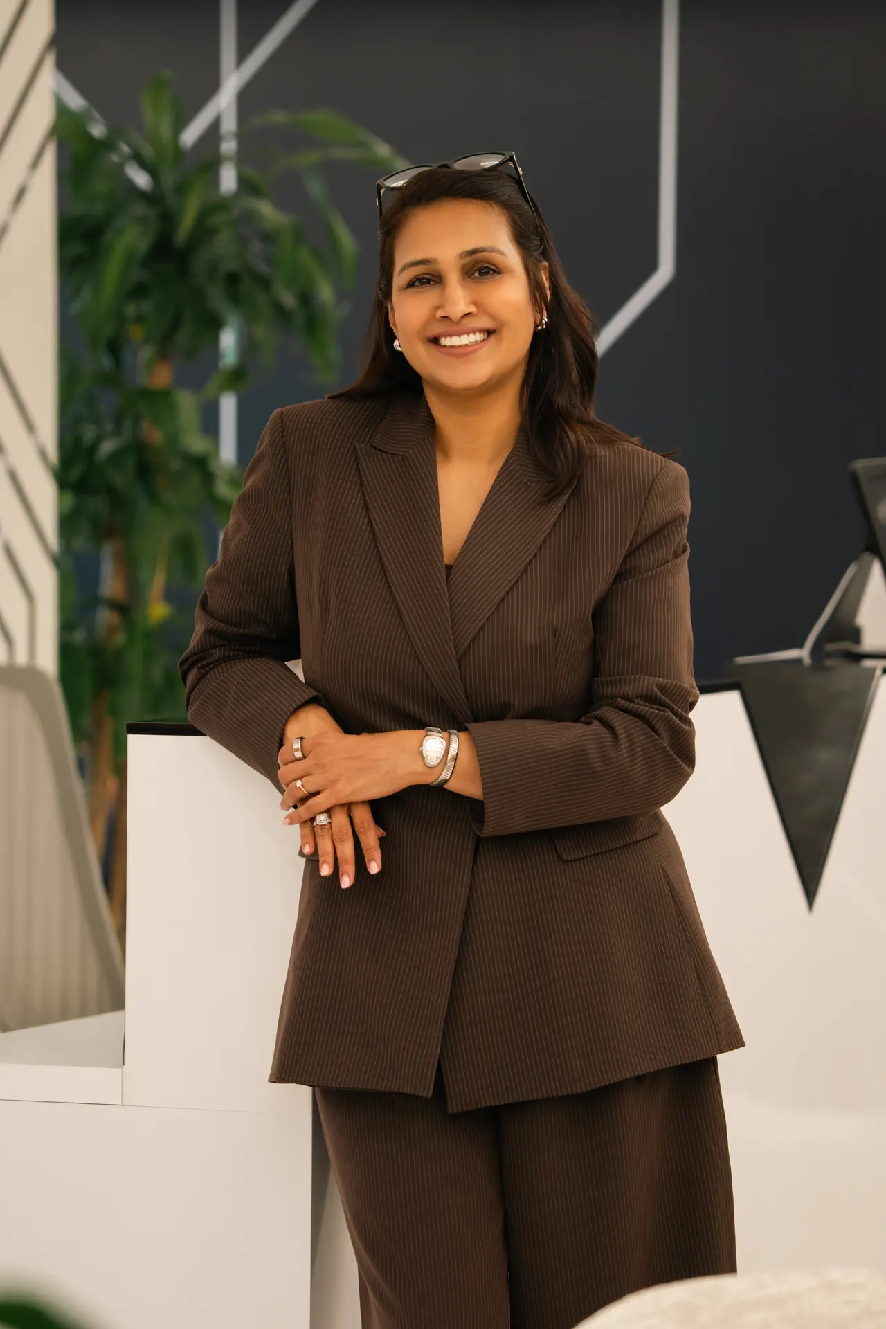 Standing portrait in a brown trouser suit in the office. On-site corporate headshot at the Nutanix office in Dubai.