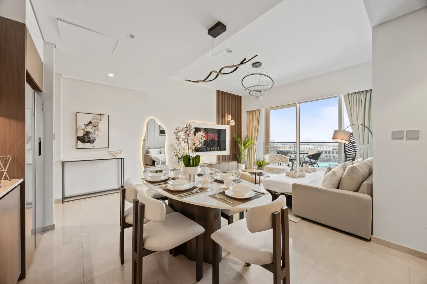 Dining table and lounge seating in a two-bedroom StayComfy Holiday Homes apartment at Grande Signature, Downtown Dubai.