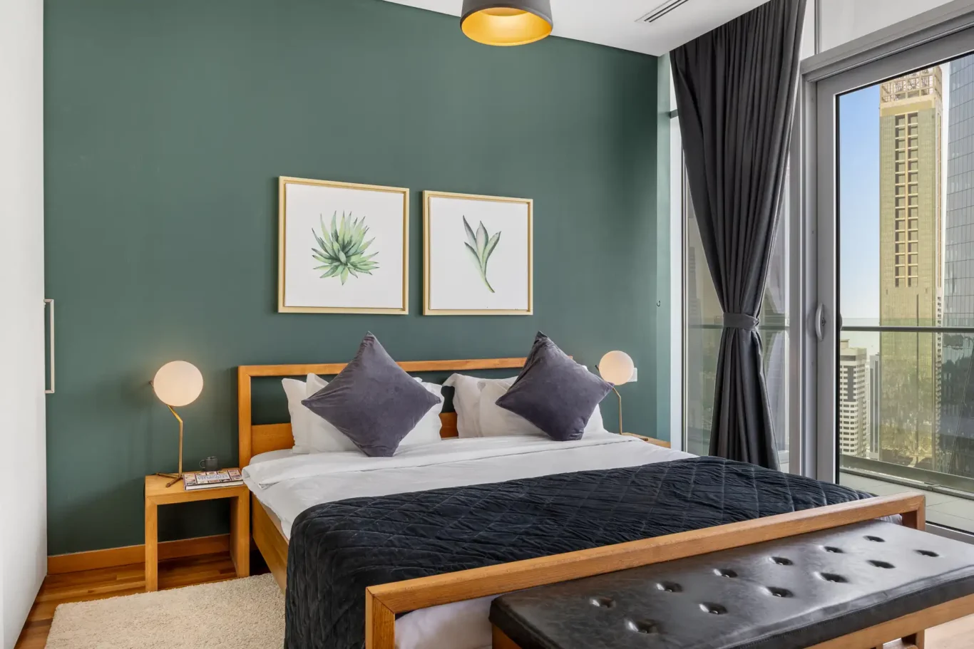Bedroom with botanical artwork above the bed in a Your Stay Apartments one-bedroom at Burj Daman, DIFC, Dubai.