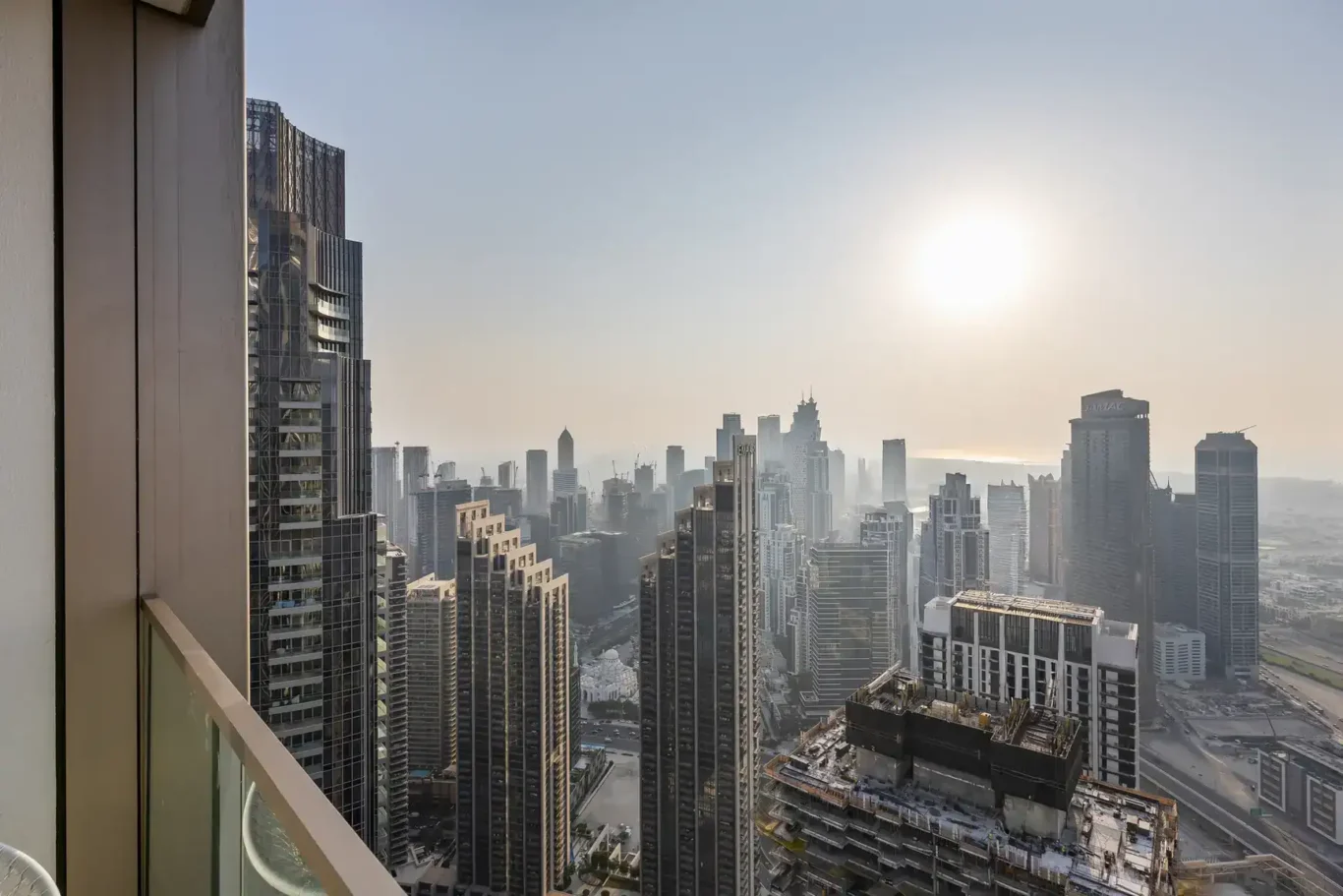 High floor view over Downtown Dubai towers with the sun over the city. Airbnb photography by MRPS for Solea Stay in Dubai.