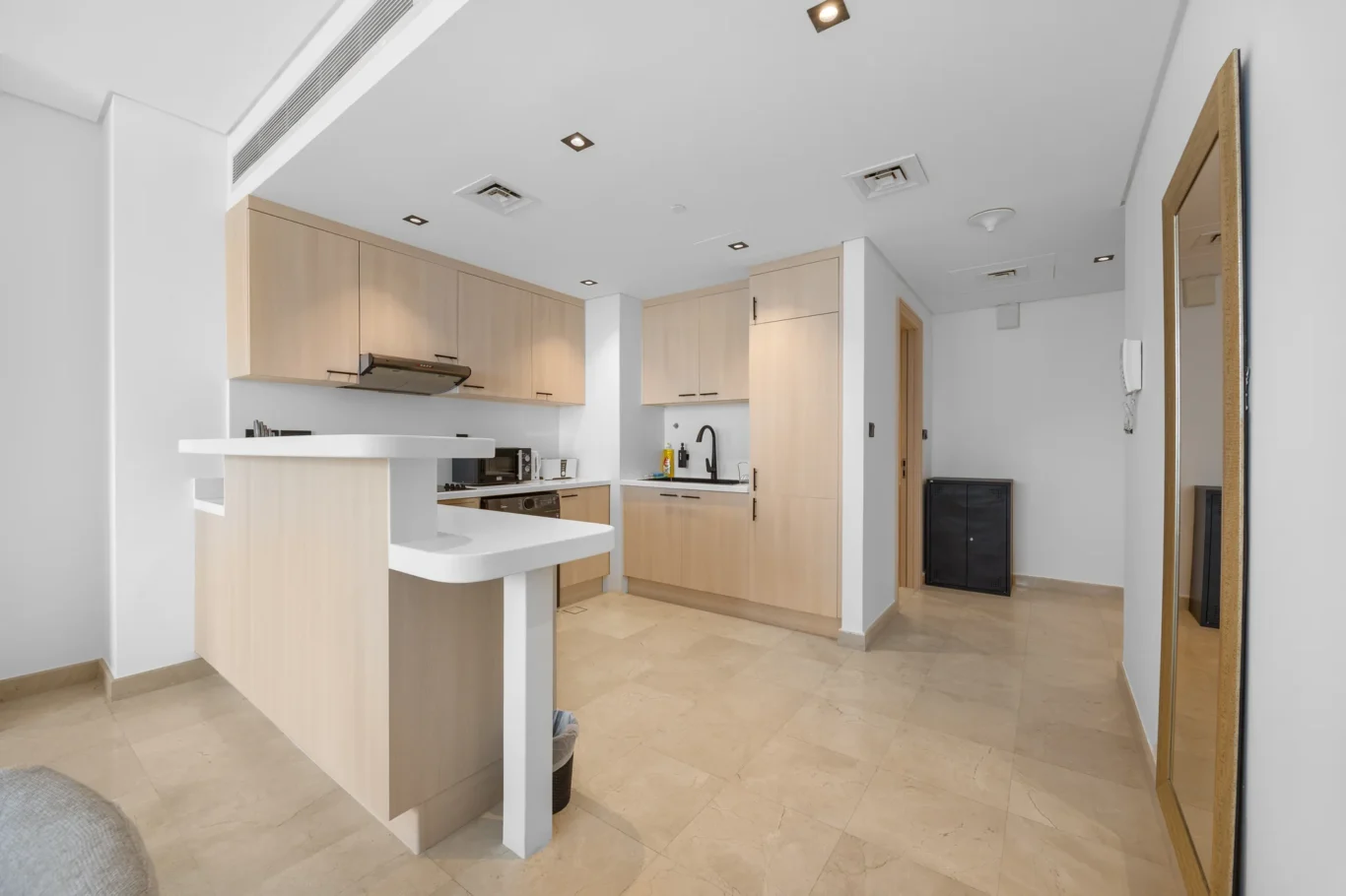 Kitchen and breakfast counter in a Your Stay Apartments one-bedroom at Sky Gardens, DIFC, Dubai.