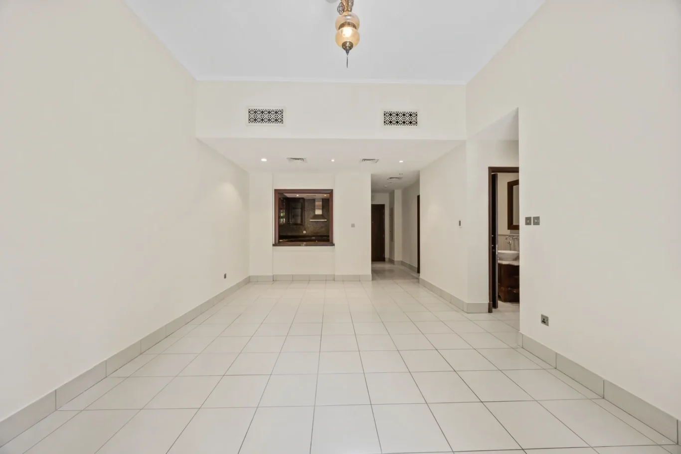 Living area leading to the hallway in an unfurnished two-bedroom garden apartment in Old Town, Downtown Dubai, photographed for ELITE Property Brokerage.