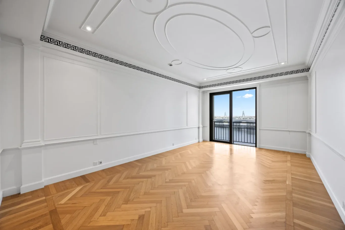 Master bedroom with herringbone parquet and decorative ceiling in a three-bedroom residence at Palazzo Versace Dubai, Jaddaf Waterfront, photographed for Concierge Auctions.