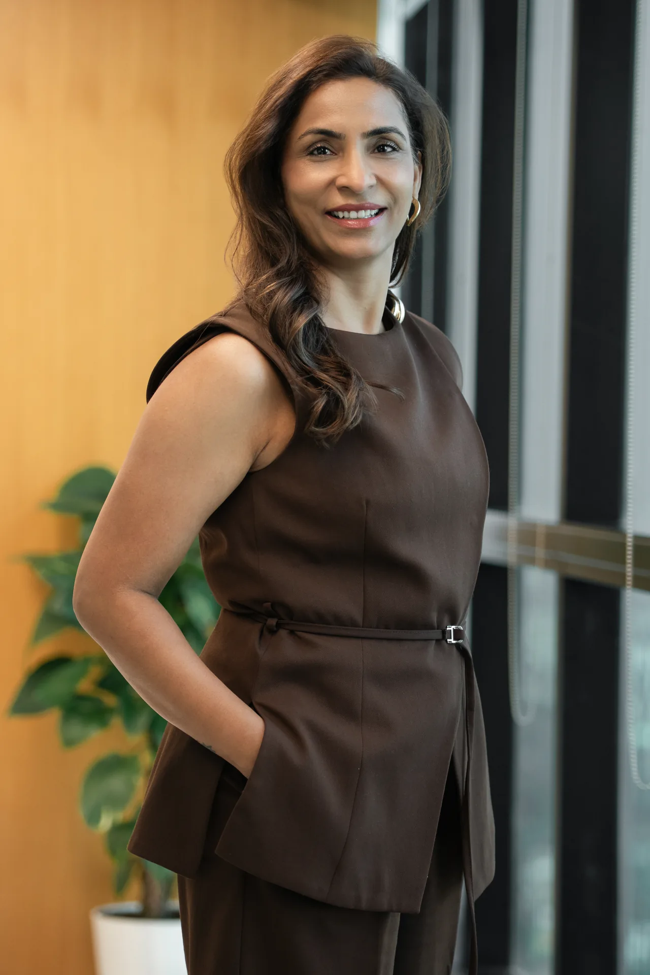 Standing portrait beside the office windows. On-site corporate headshot at the Nutanix office in Dubai.