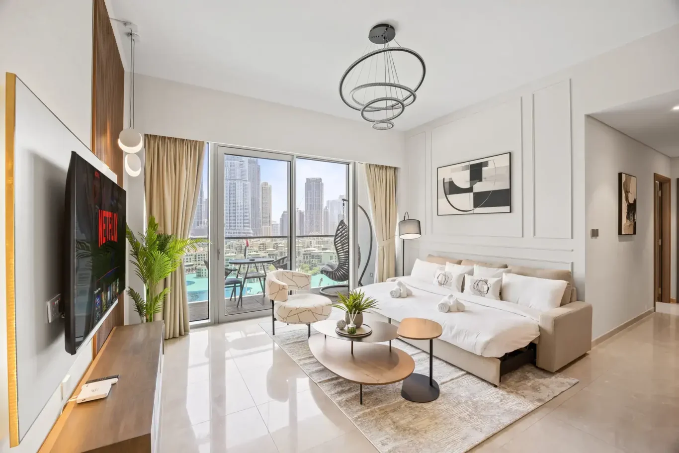 Living room with smart TV in a two-bedroom StayComfy Holiday Homes apartment at Grande Signature, Downtown Dubai.