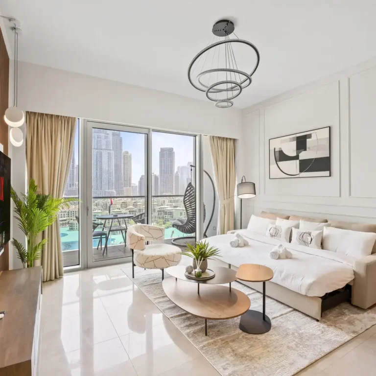 Living room with smart TV in a two-bedroom StayComfy Holiday Homes apartment at Grande Signature, Downtown Dubai.