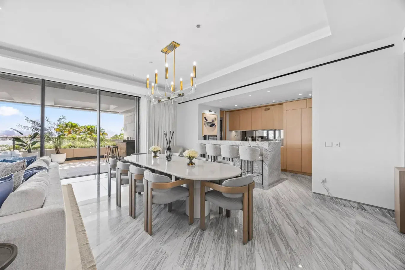 Dining area leading to the kitchen in a furnished three-bedroom residence at Atlantis The Royal, Palm Jumeirah, photographed for Apex Homes Real Estate.