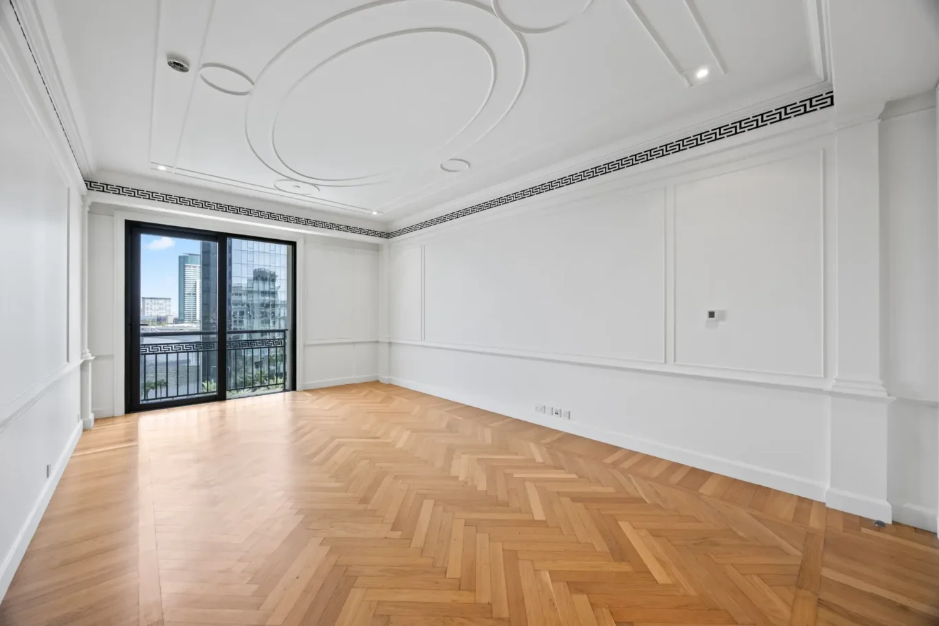 Master bedroom with balcony door and moulded walls in a three-bedroom residence at Palazzo Versace Dubai, Jaddaf Waterfront, photographed for Concierge Auctions.
