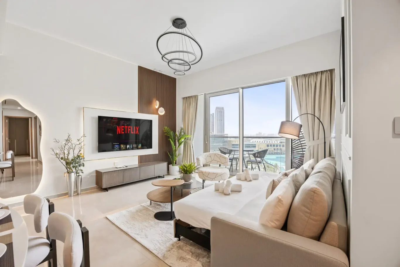 Living room sofa and TV wall in a two-bedroom StayComfy Holiday Homes apartment at Grande Signature, Downtown Dubai.