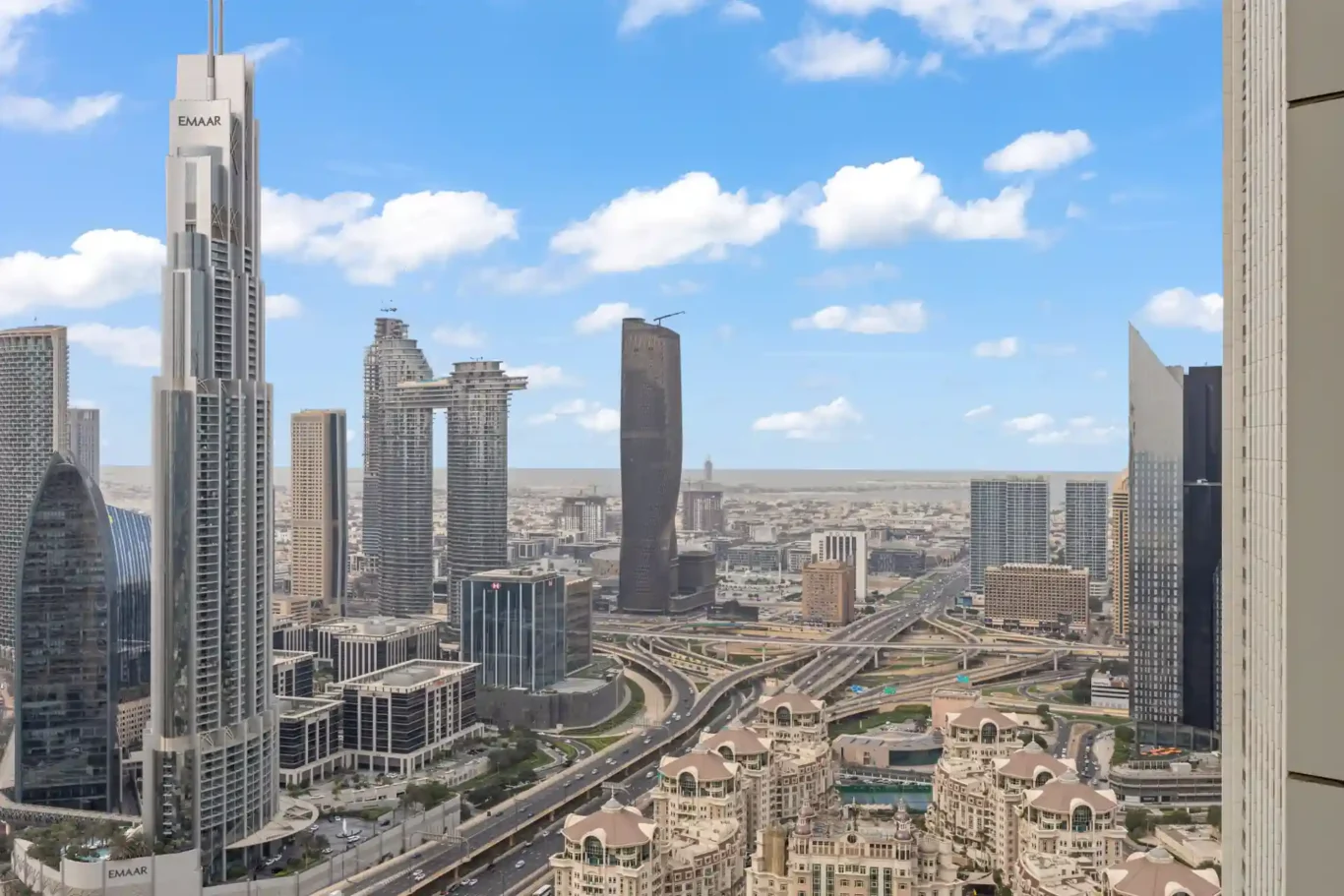 Daylight view over Downtown Dubai towers and the roads below. Day, twilight and night Airbnb photography by MRPS for Vista Haus Holiday Homes in Downtown Dubai.