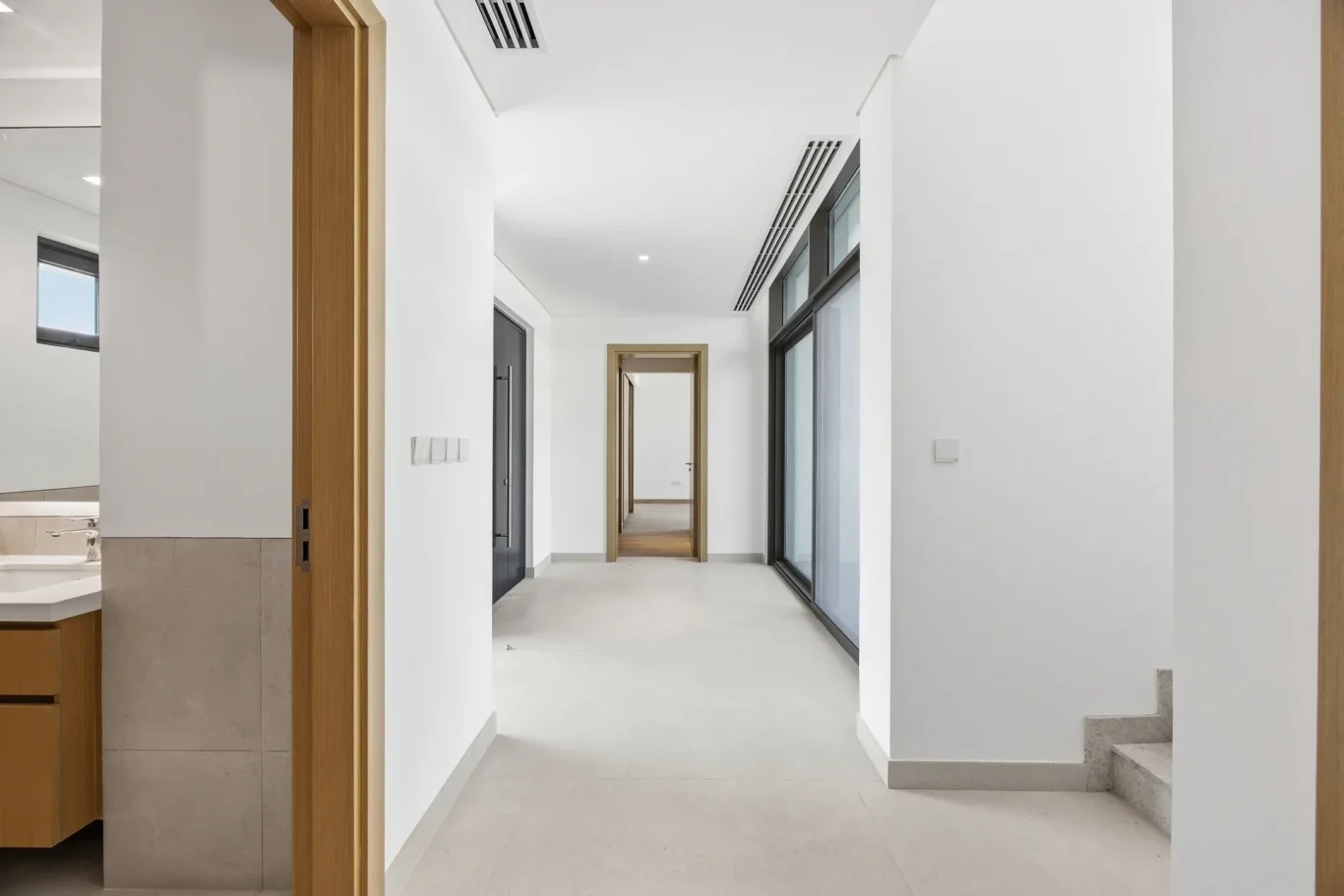 Ground floor hallway leading to the staircase. Villa photography by MRPS in Dubai for ELITE Property Brokerage.