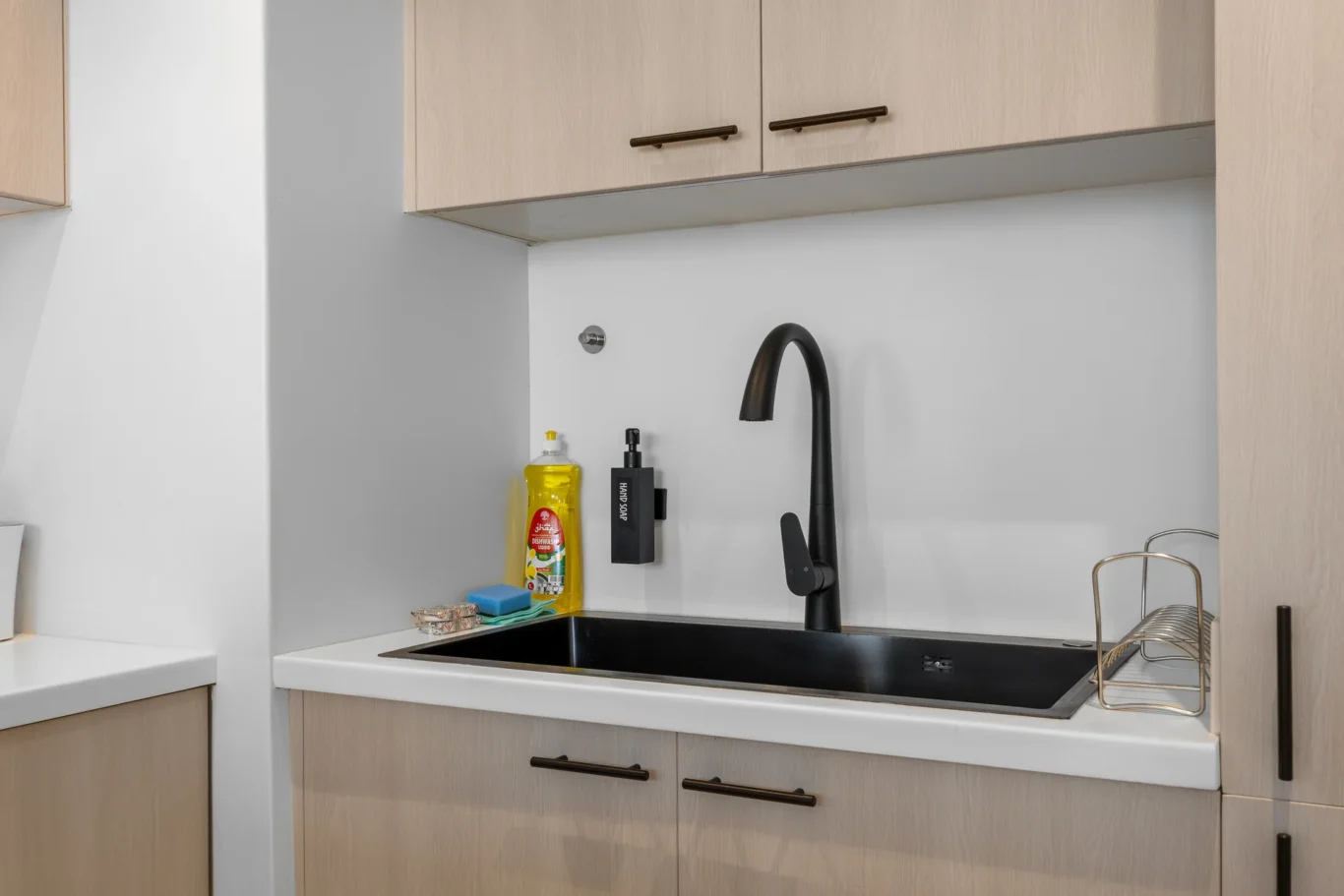 Kitchen sink and cabinets in a Your Stay Apartments one-bedroom at Sky Gardens, DIFC, Dubai.