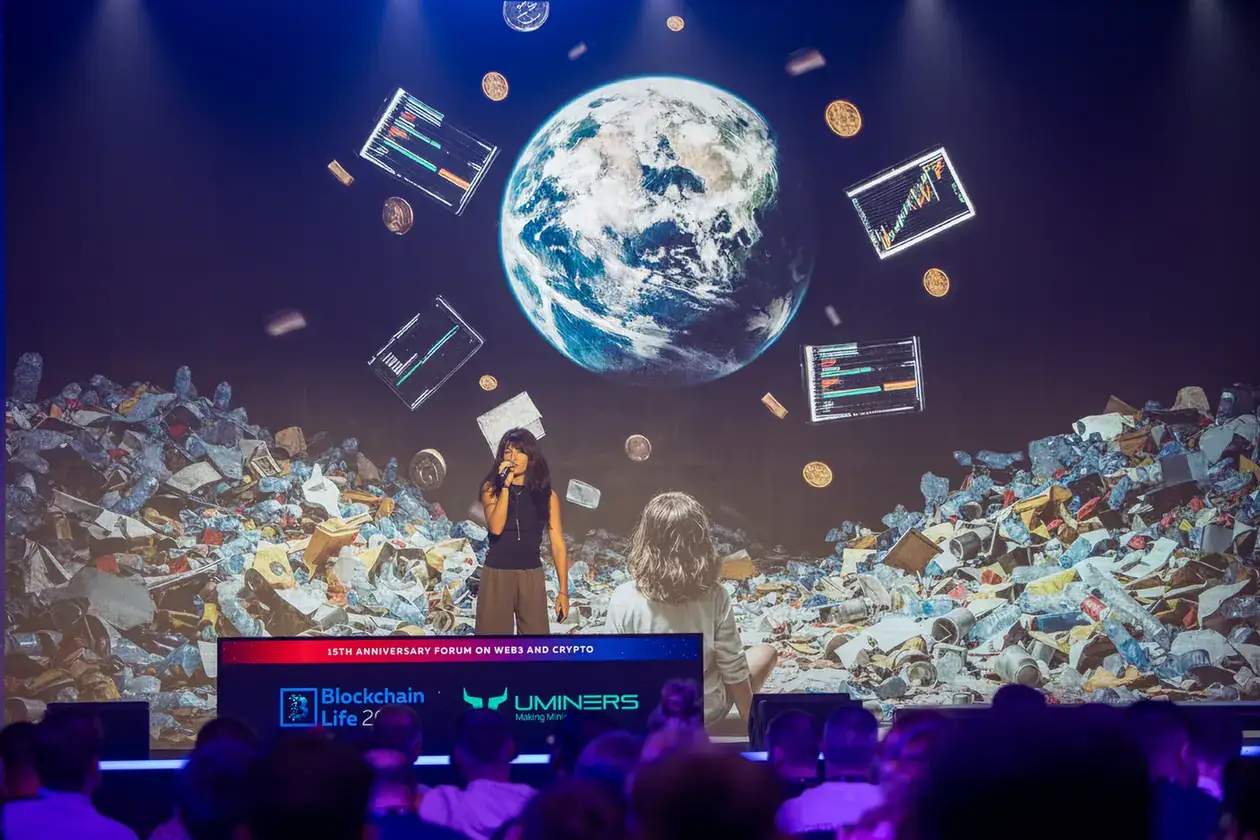 Speaker in front of large stage visuals. Event photography by MRPS at Blockchain Life 2025, Festival Arena, Dubai.