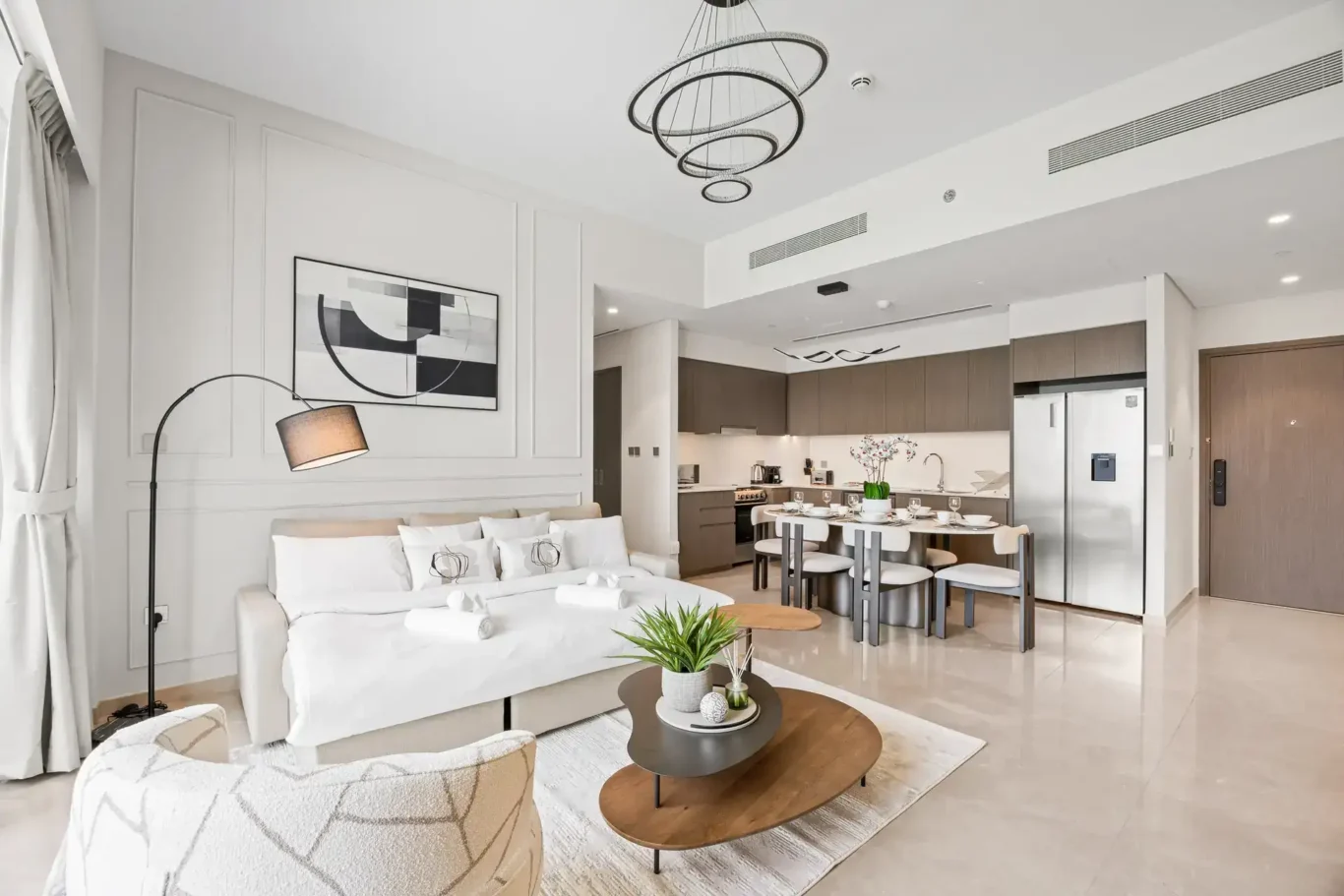 Living room towards kitchen in a two-bedroom StayComfy Holiday Homes apartment at Grande Signature, Downtown Dubai.