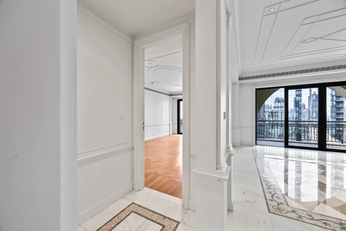Bedroom doorway with parquet floor and balcony beyond in a three-bedroom residence at Palazzo Versace Dubai, Jaddaf Waterfront, photographed for Concierge Auctions.