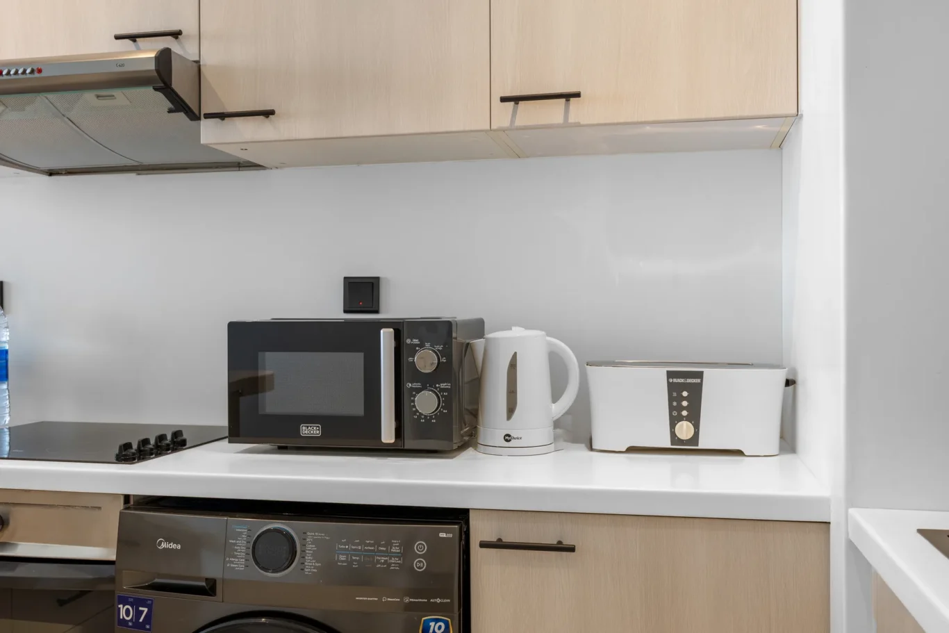Microwave, kettle and toaster on the worktop in a Your Stay Apartments one-bedroom at Sky Gardens, DIFC, Dubai.