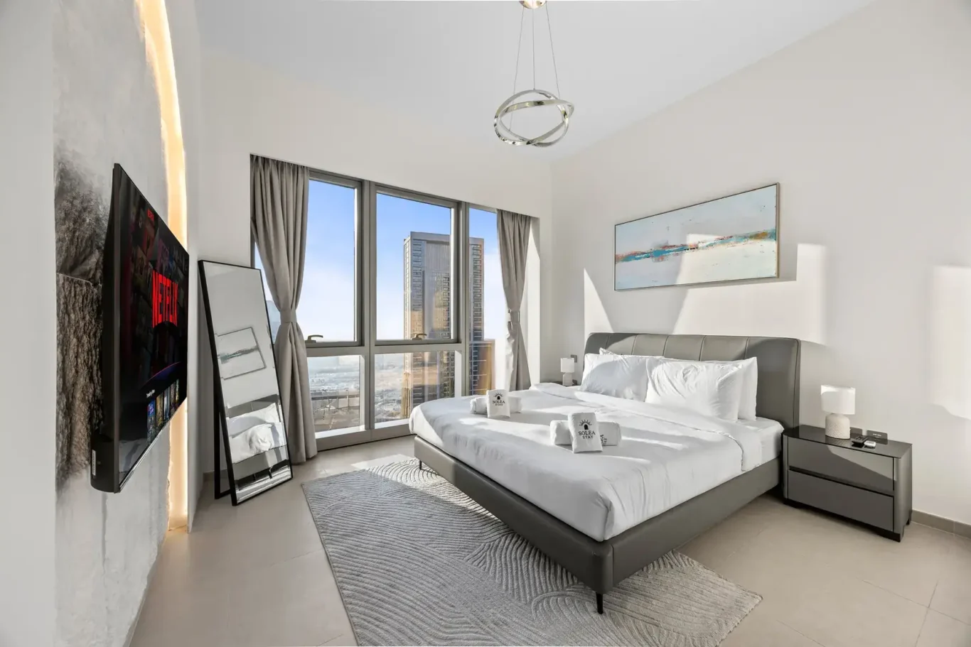 Master bedroom with king bed, wall art and city view. Airbnb photography by MRPS for Solea Stay in Dubai.