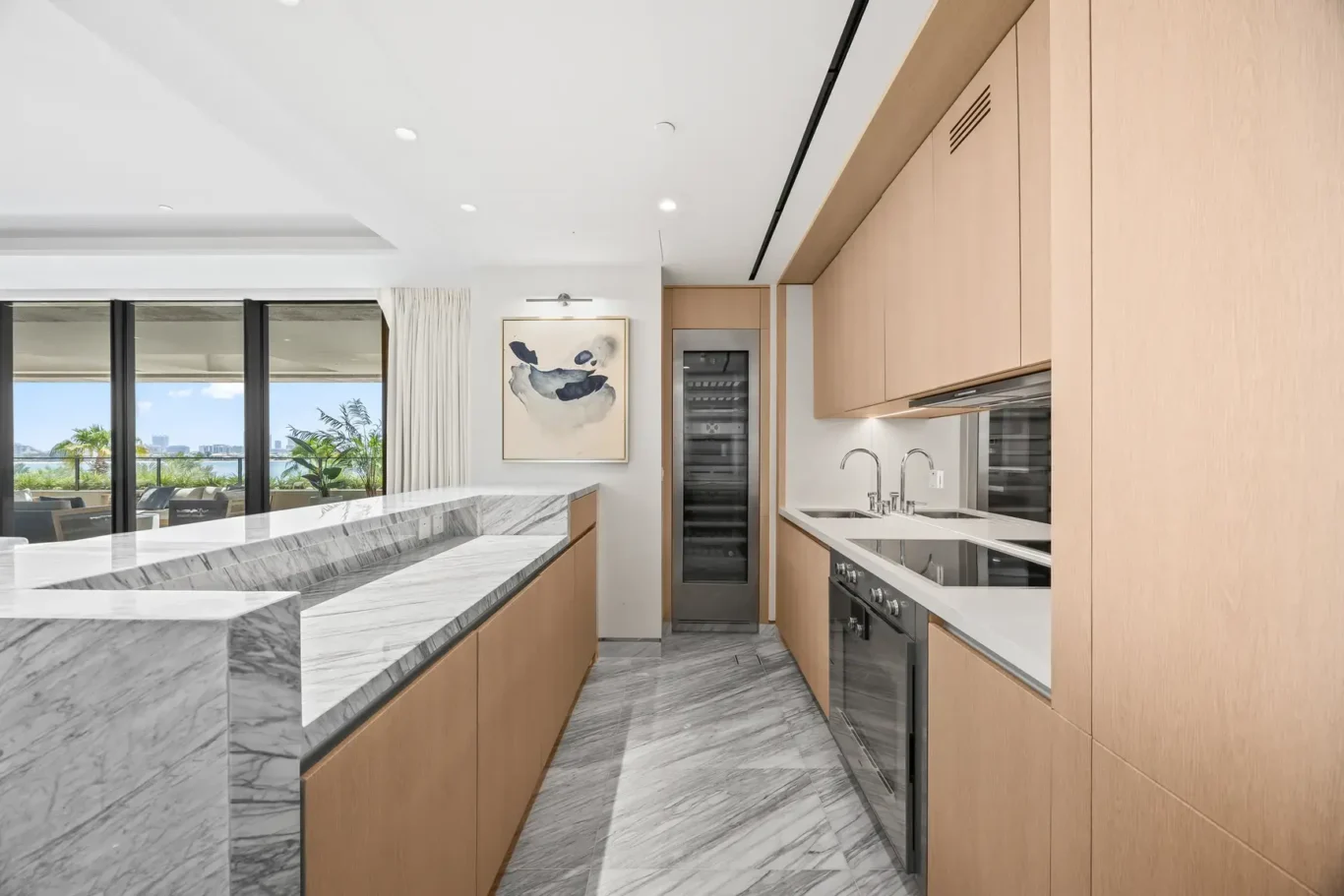 Fitted kitchen with marble worktops and built-in appliances in a furnished three-bedroom residence at Atlantis The Royal, Palm Jumeirah, photographed for Apex Homes Real Estate.