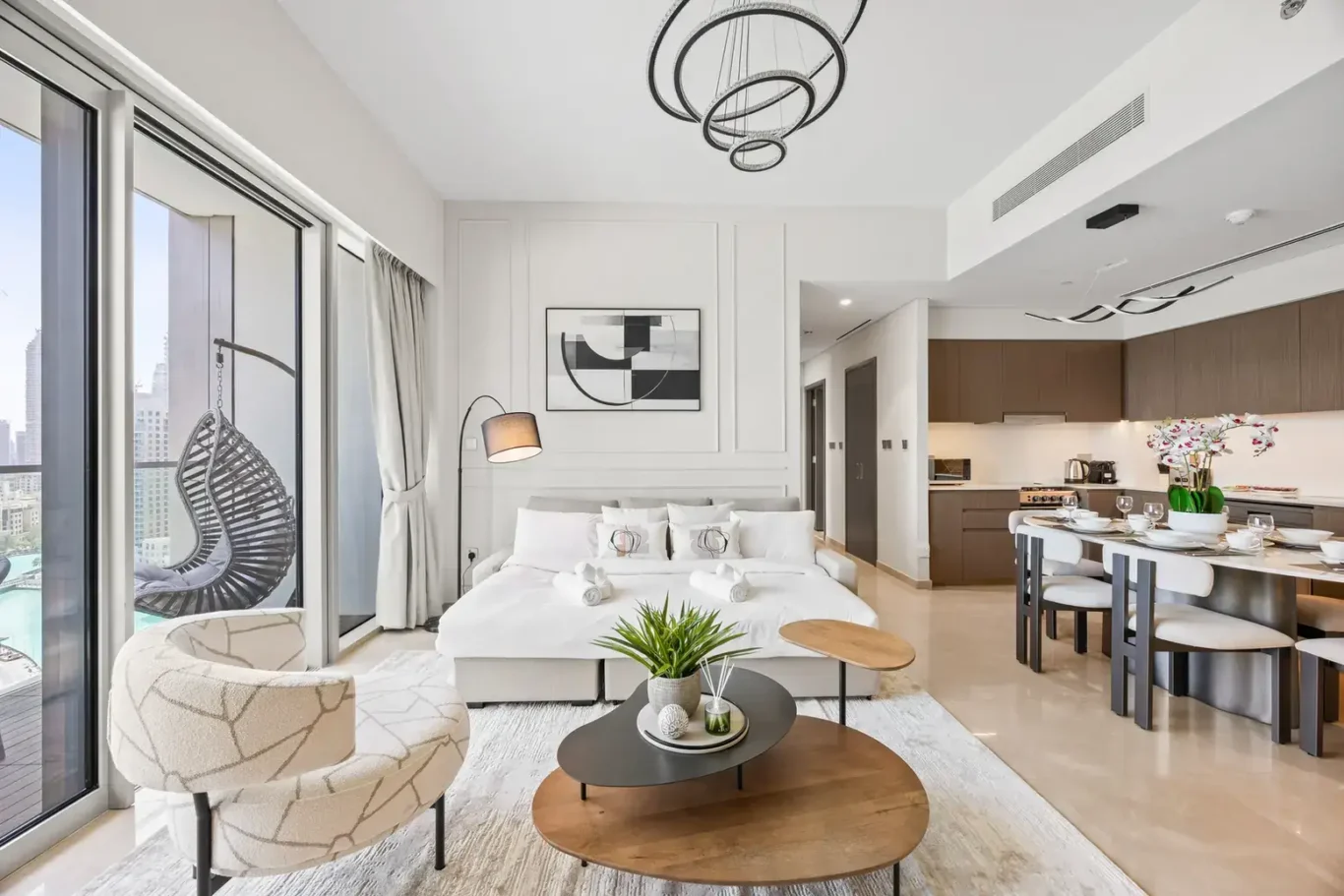 Living area with balcony access in a two-bedroom StayComfy Holiday Homes apartment at Grande Signature, Downtown Dubai.