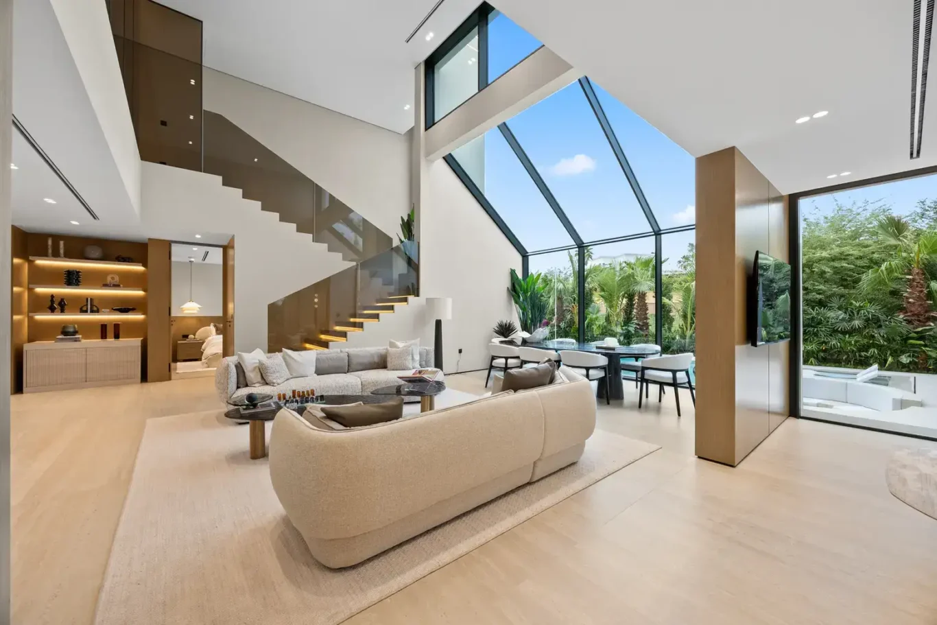 Living room and dining area under the mezzanine, luxury villa in Jumeirah Islands, Dubai.