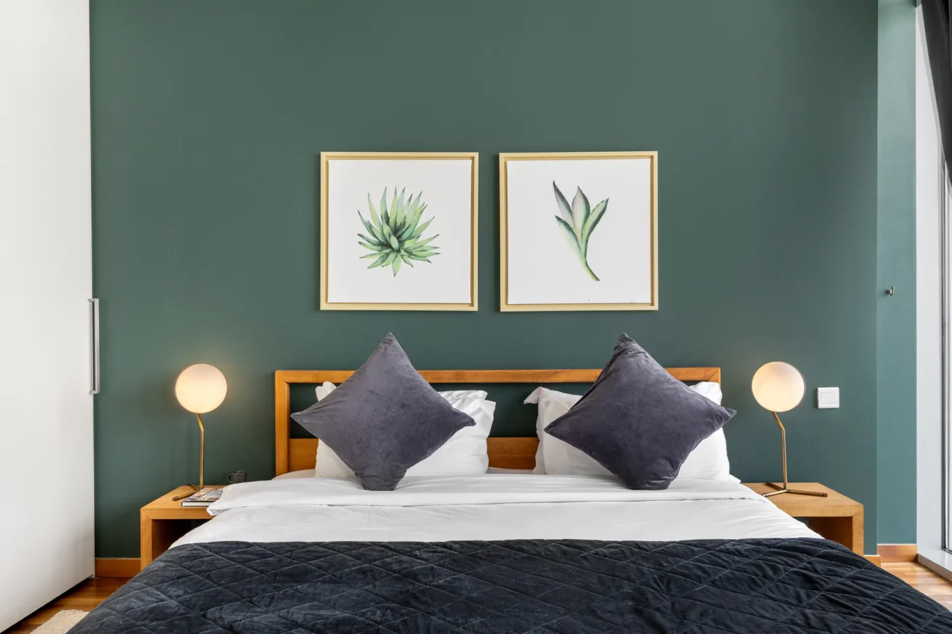 King bed with bedside lamps in a Your Stay Apartments one-bedroom at Burj Daman, DIFC, Dubai.