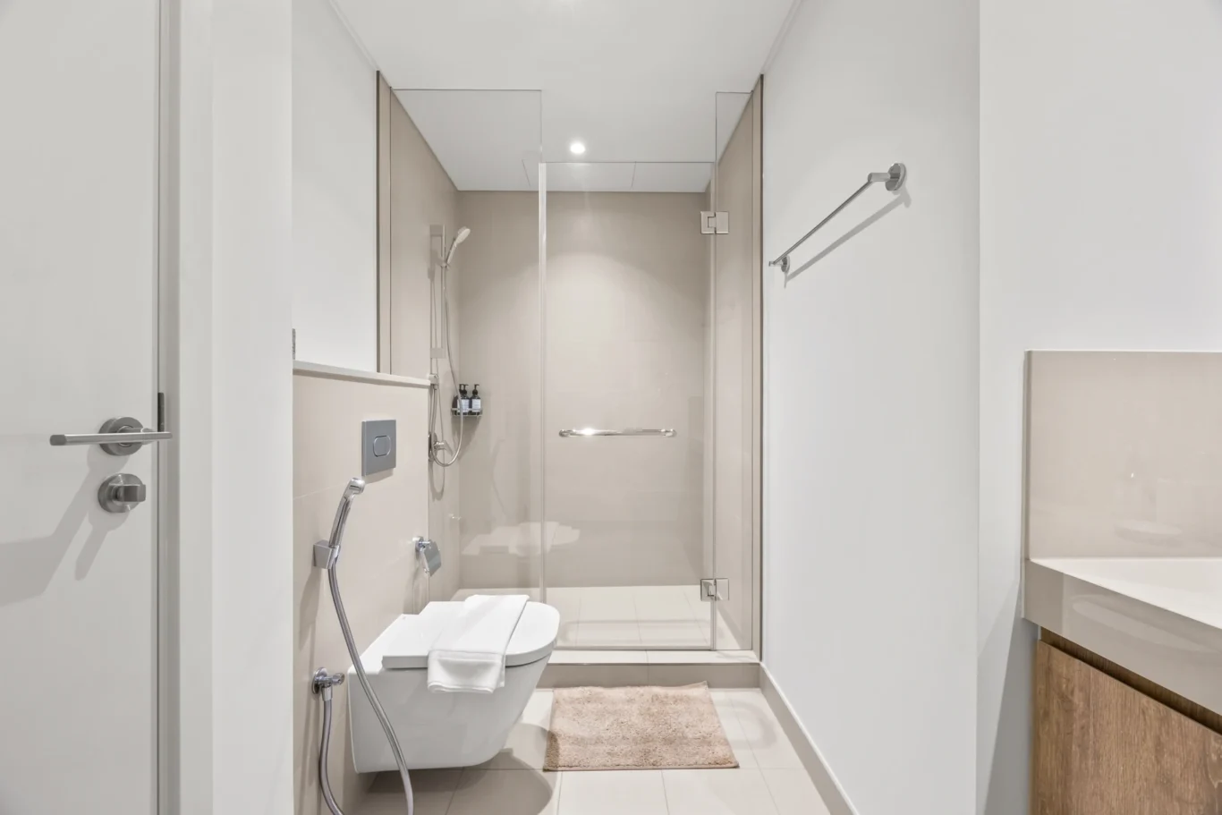Master ensuite bathroom with walk in shower and towels. Day, twilight and night Airbnb photography by MRPS for Vista Haus Holiday Homes in Downtown Dubai.