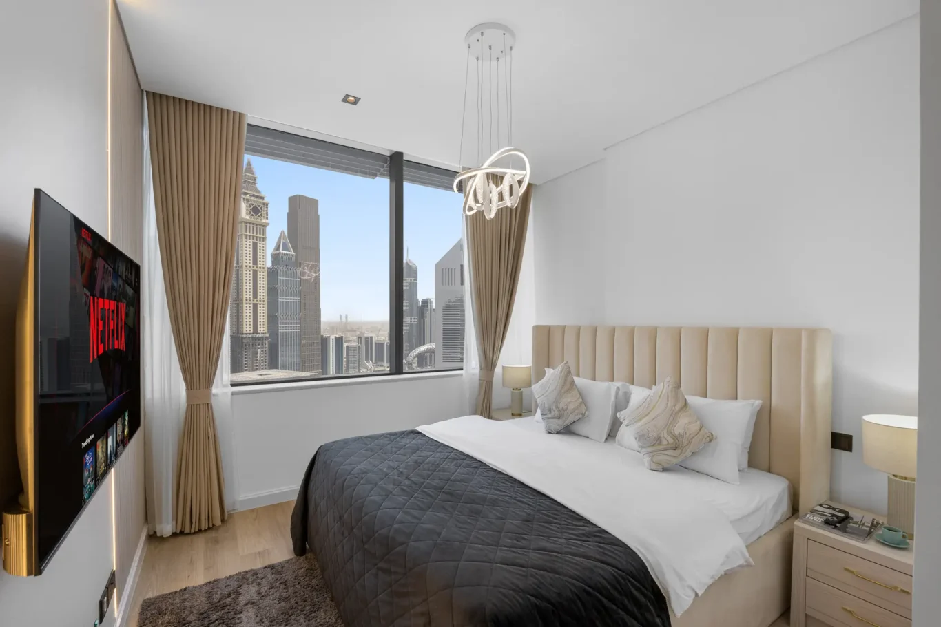 Bed and window with DIFC view in a Your Stay Apartments one-bedroom at Sky Gardens, DIFC, Dubai.