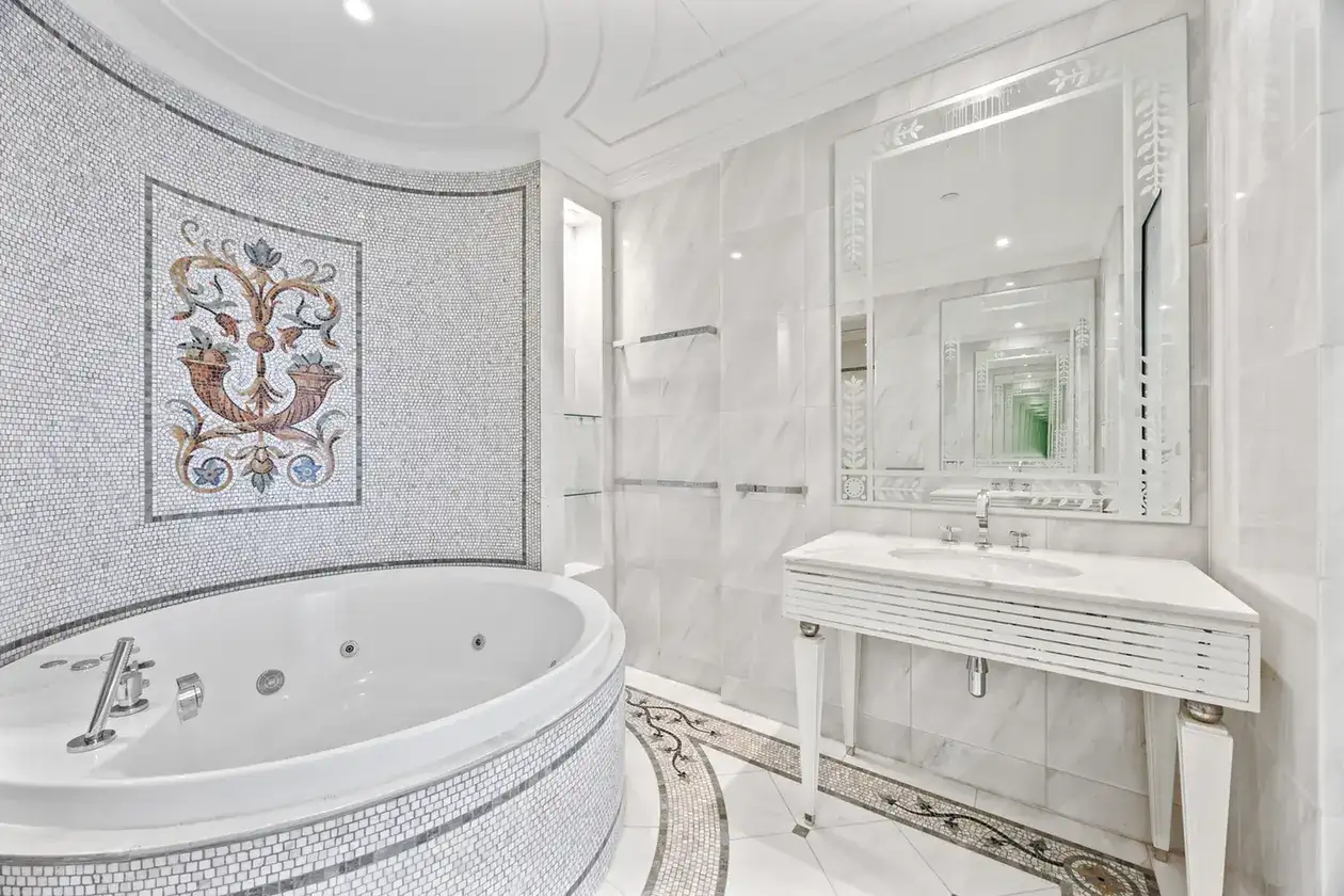 Master bathroom with mosaic wall art and jacuzzi bathtub in a three-bedroom residence at Palazzo Versace Dubai, Jaddaf Waterfront, photographed for Concierge Auctions.