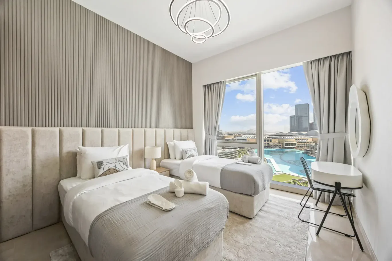 Twin bedroom with city view in a two-bedroom StayComfy Holiday Homes apartment at Grande Signature, Downtown Dubai.