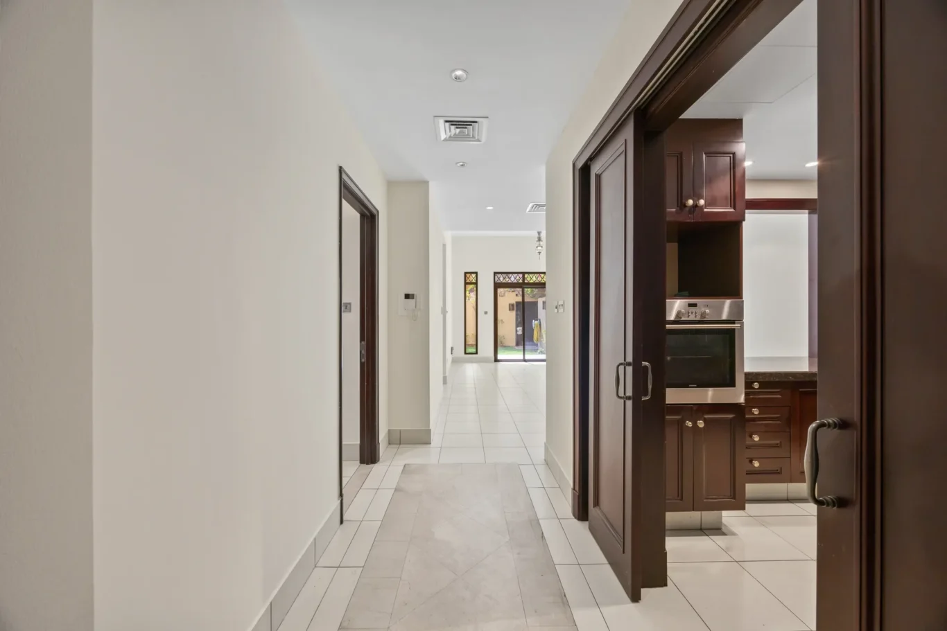 Entrance hallway leading to the kitchen in an unfurnished two-bedroom garden apartment in Old Town, Downtown Dubai, photographed for ELITE Property Brokerage.