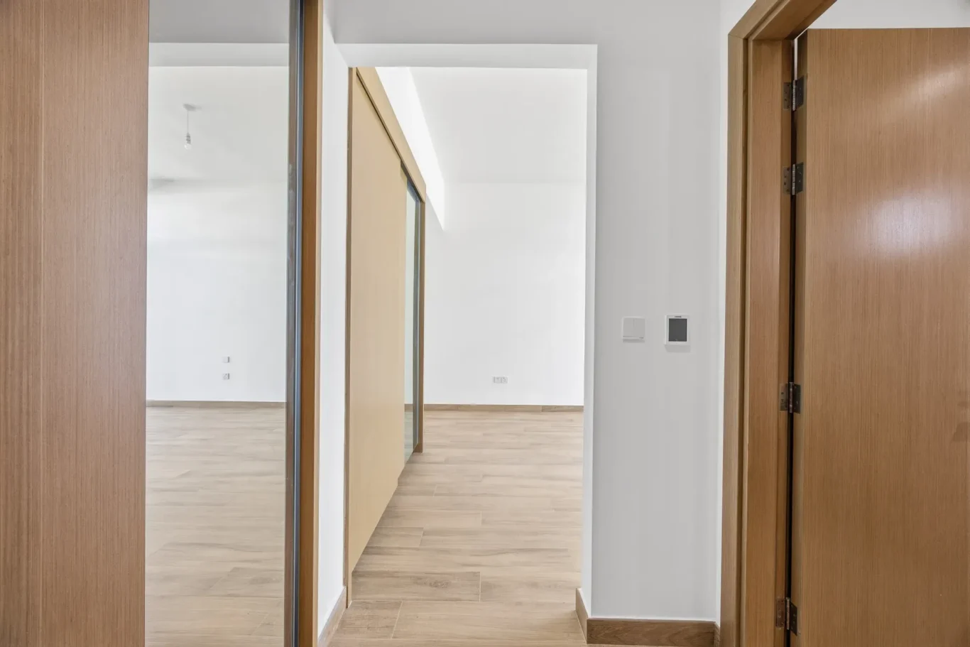 Maid room with wood flooring and built in wardrobe space. Villa photography by MRPS in Dubai for ELITE Property Brokerage.