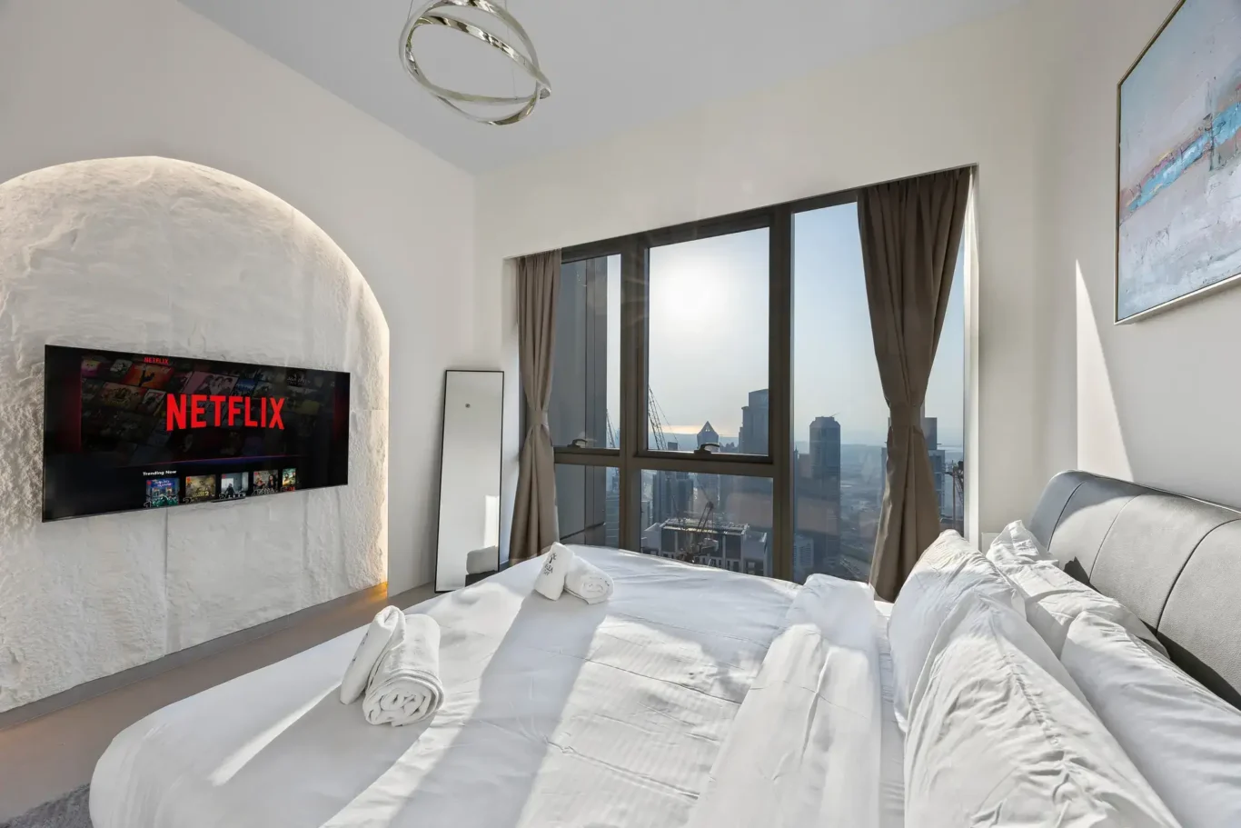 Master bedroom with sunlit skyline view through the windows. Airbnb photography by MRPS for Solea Stay in Dubai.