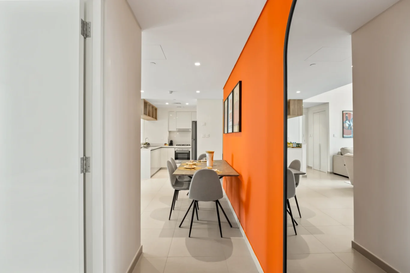 Orange corridor leading back to the living room and dining area. Day, twilight and night Airbnb photography by MRPS for Vista Haus Holiday Homes in Downtown Dubai.